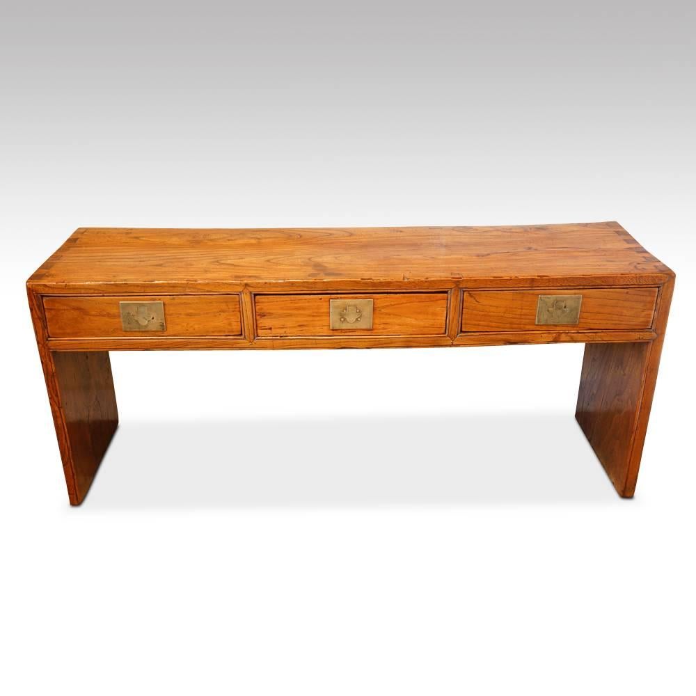 Chinese elm low side table
This Chinese elm low side table would have been made in the late 19th century.
Fitted three drawers with the unusual brass flush handles, that you push in at the top that then allows you to get to the tongue of the