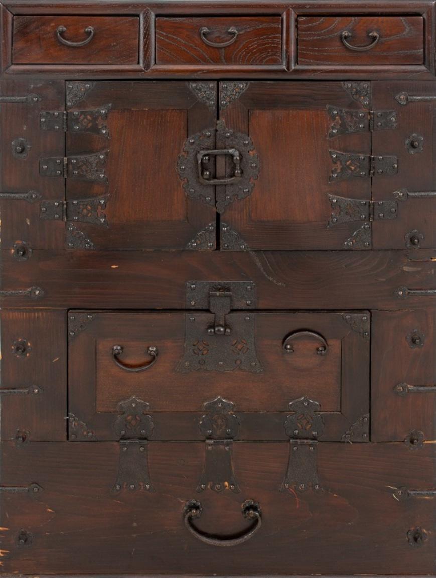 Chinese Elm wood chest, of rectangular form with three short drawers above a two door cabinet front and locking lower chamber, the whole mounted with cast-iron fittings. 

Dimensions:  27