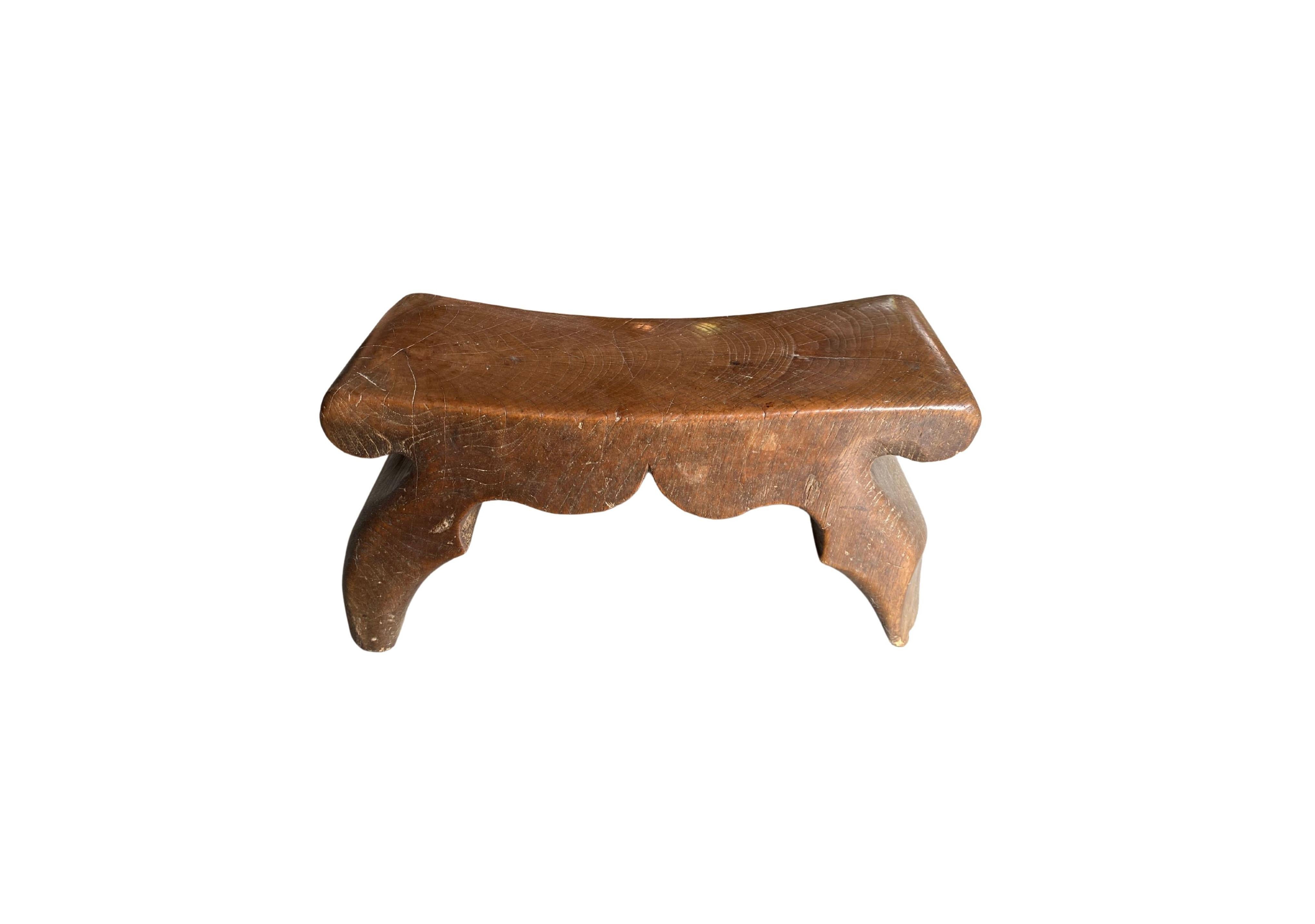 This antique Chinese headrest was crafted from elmwood and has a wonderfully smooth texture. It likely belonged to an upper-class individual to support their head. This piece has a lovely wood texture, curved ends and subtle engravings. 

 