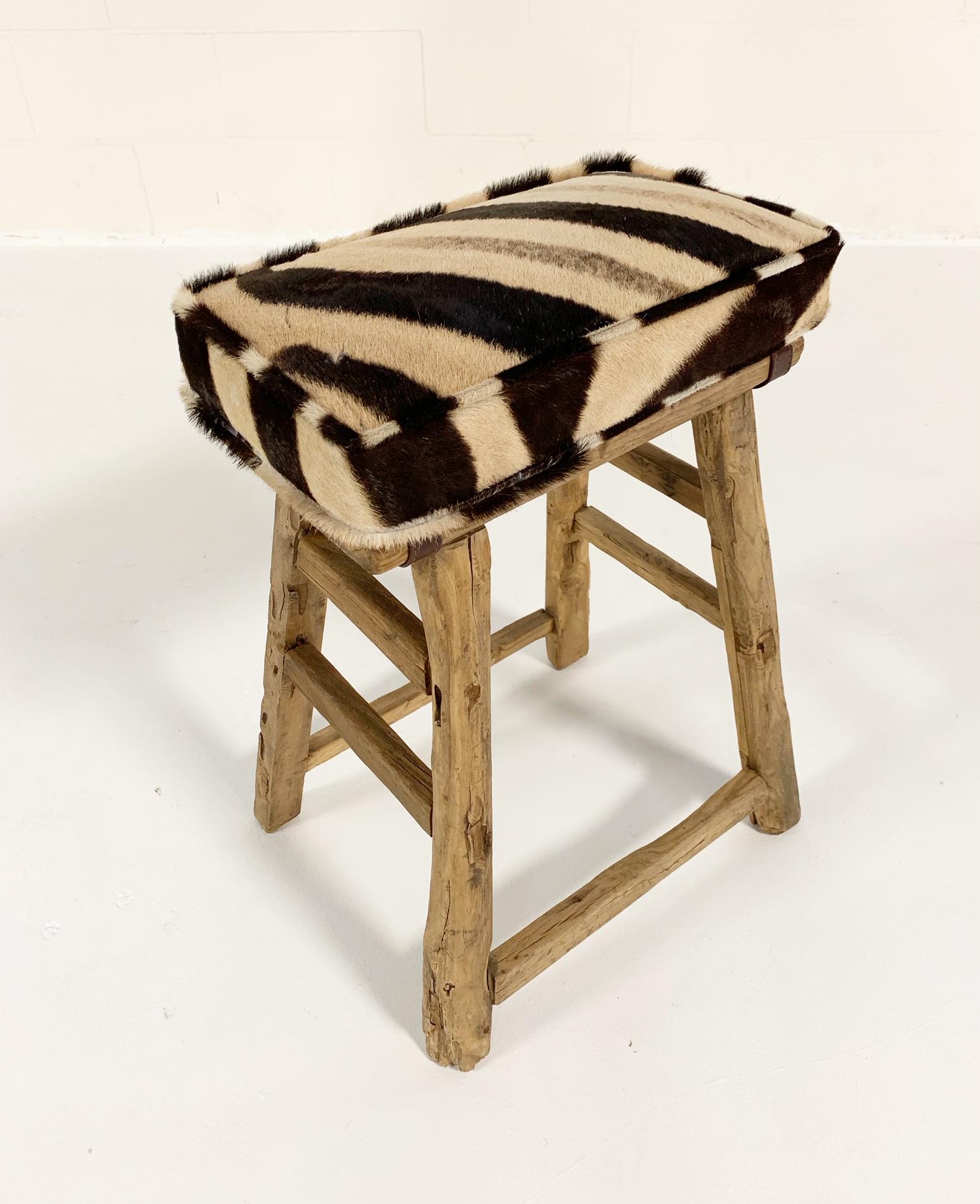 Really nice, simple-profile 19th century Chinese elmwood stool to pull up anywhere. We added a custom zebra hide cushion for comfort. 

5 available.