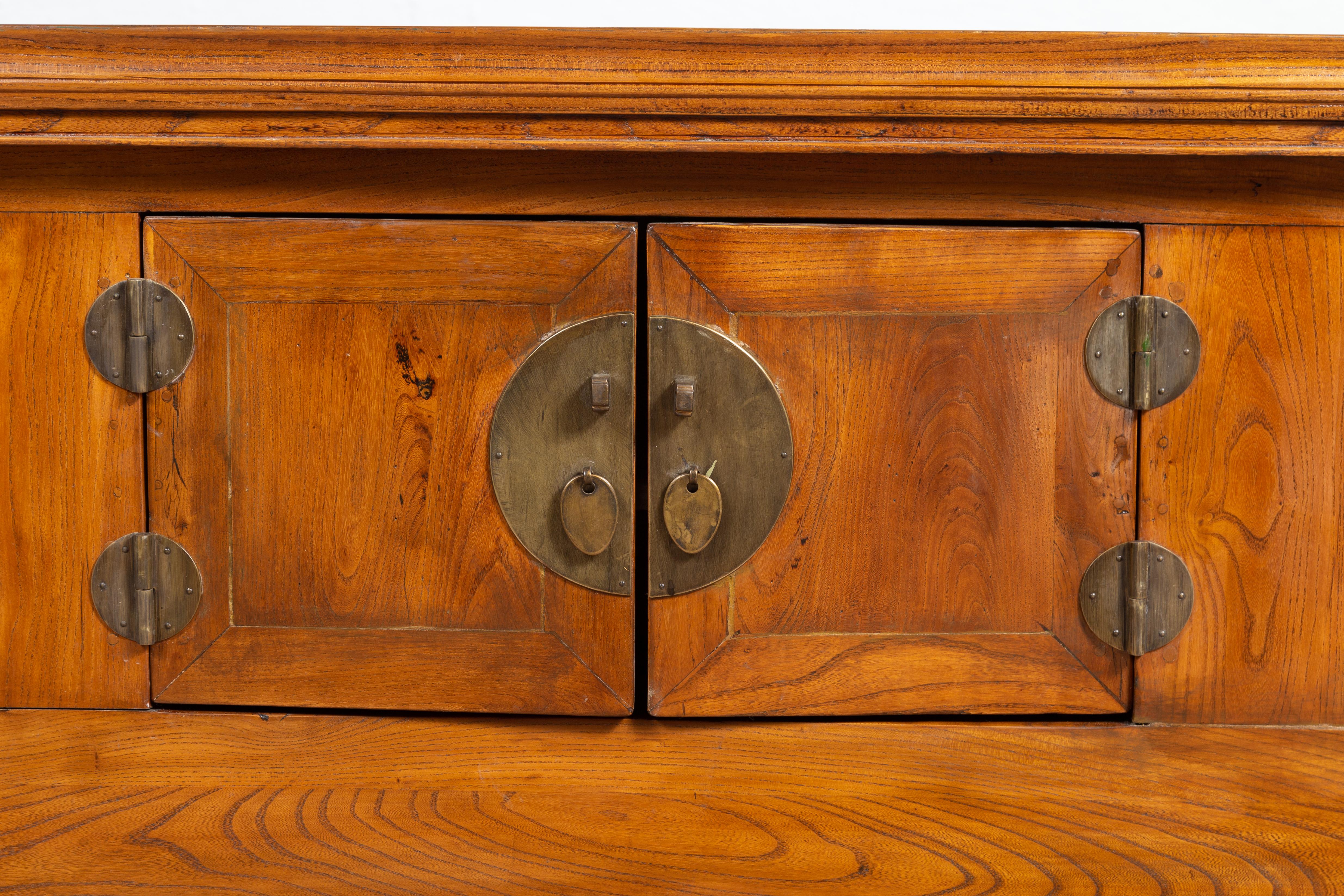 19th Century Qing Dynasty Elmwood Two-Door Low Kang Cabinet with Everted Flanges and Scrolls For Sale