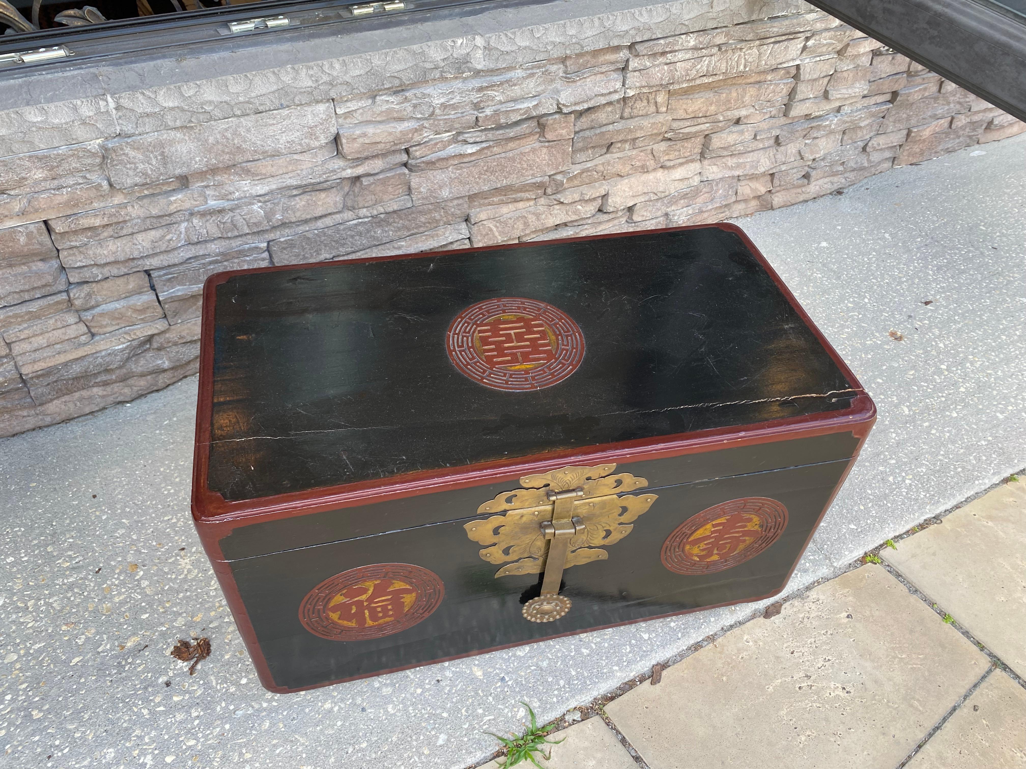 The Chinese hand crafted trunk has a double happiness emblem on the top
Handles to the sides background in black with several red medallions
Wonderful condition.