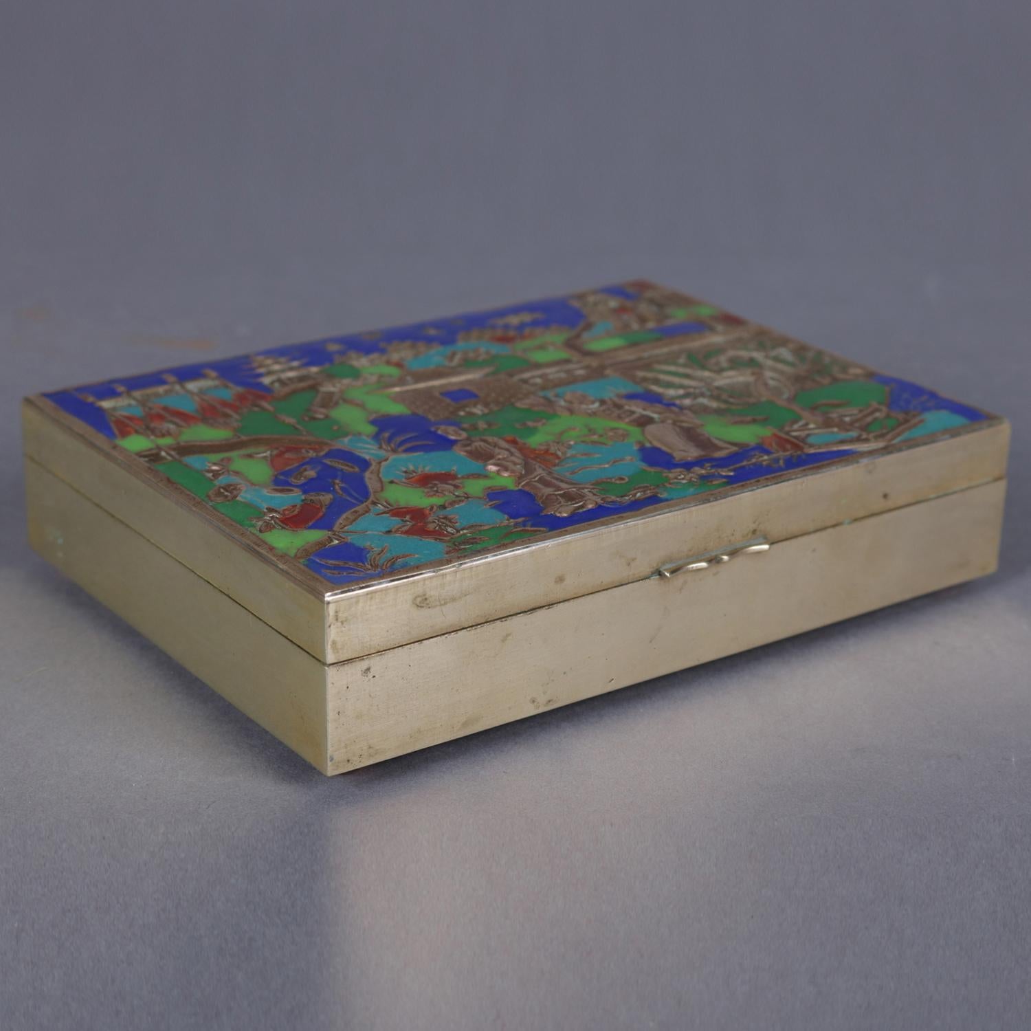 Chinese pictorial brass dresser box features hinged lid with enameled village courting scene and seated on ball feet, divided interior, 20th century

Measures - 1.5