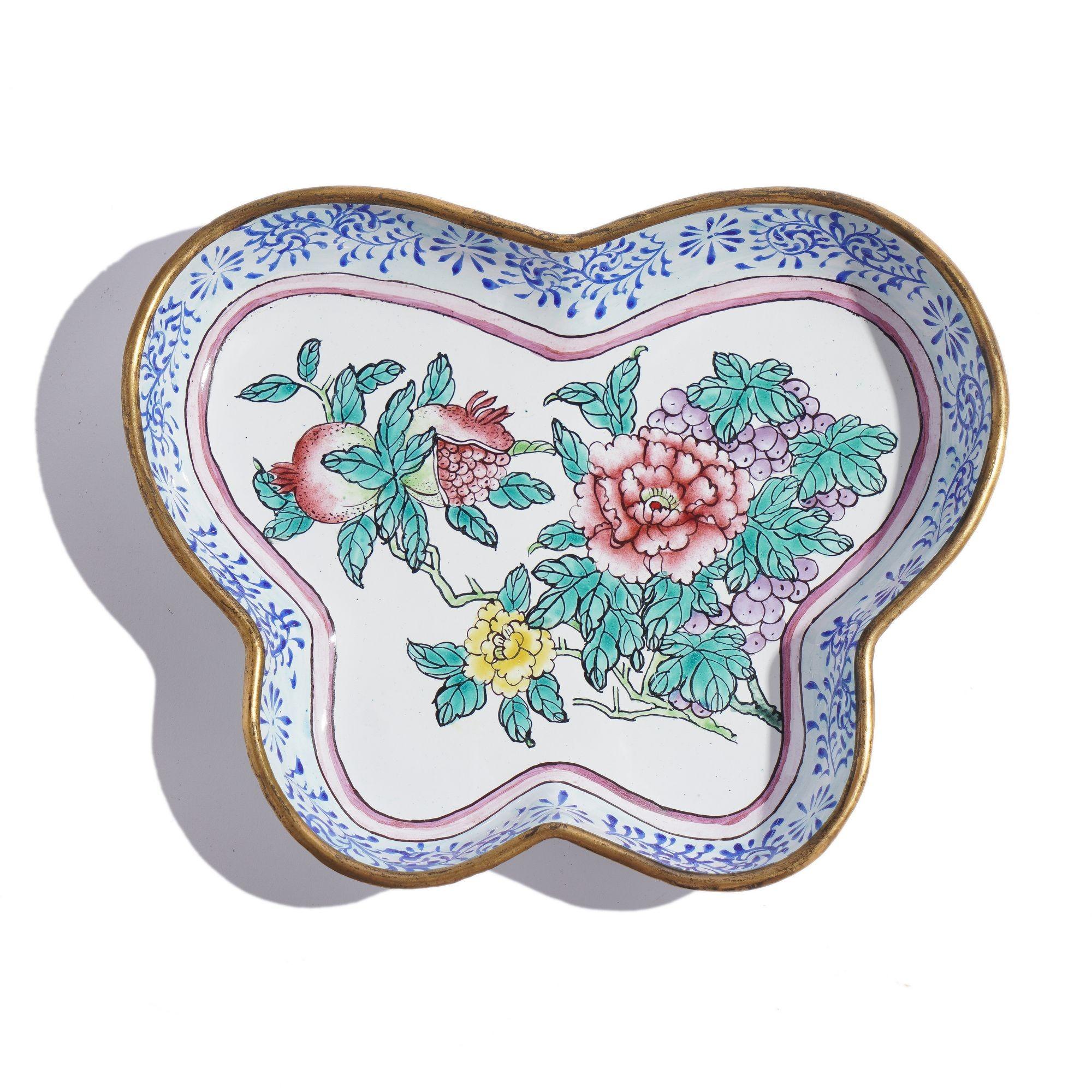 Chinese polychrome enamel decorated butterfly form pin ray with a standing cobalt blue patterned border with a central motif of peonies and pomegranates.

China, circa 1950.