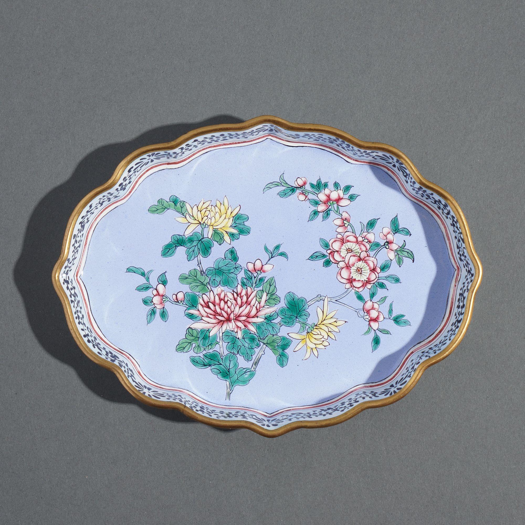 Standing rim enameled brass shaped pin tray. The decoration of mums & cherry blossoms on a periwinkle blue ground is framed with black trailing vine on the interior of the standing rim.

China, mid 20th century.