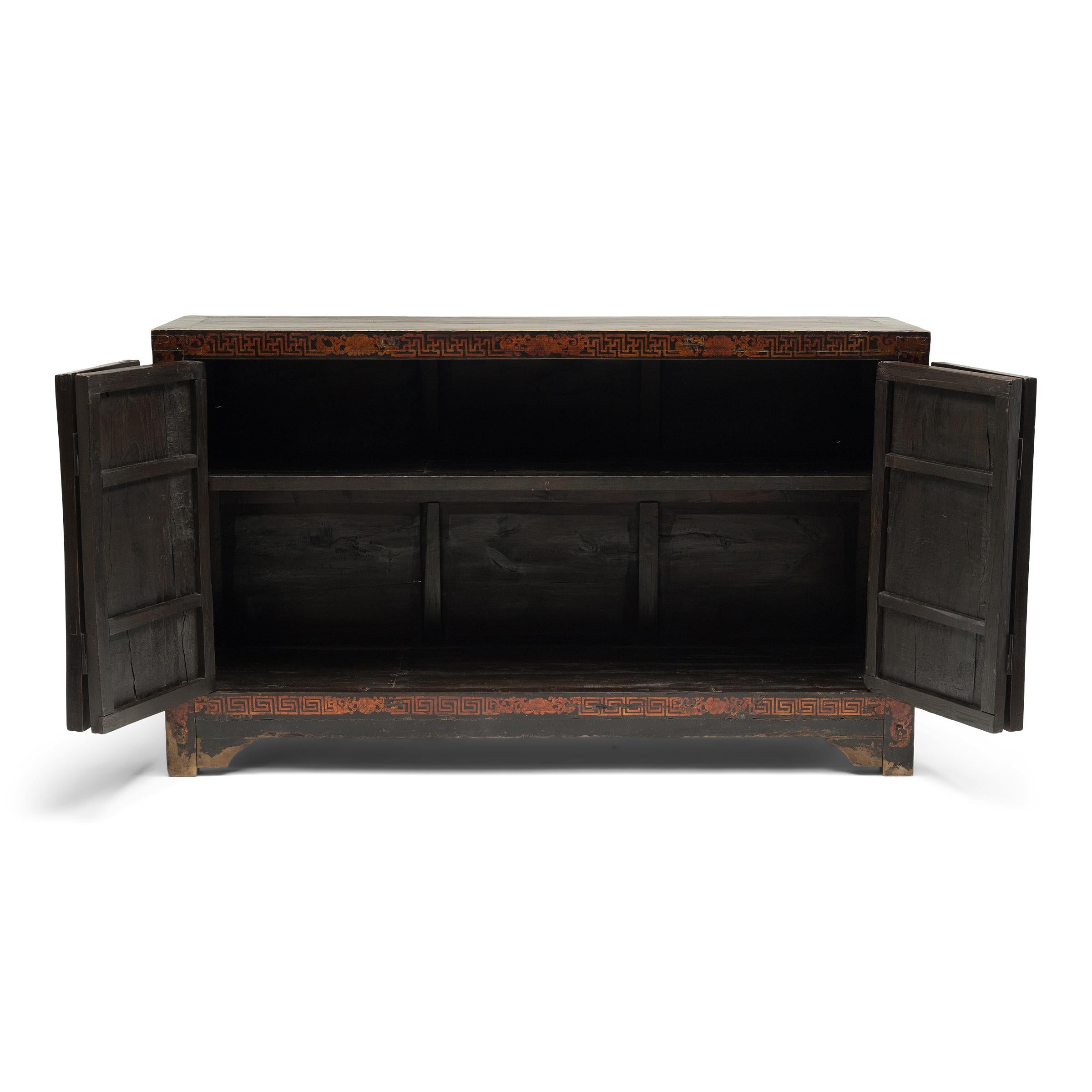 This elegant 19th-century coffer was crafted of elm (yumu) with a square corner frame and four doors, each decorated with a traditional bird-and-flower painting. The serene garden vignettes depict the flowers of the four seasons, including plum