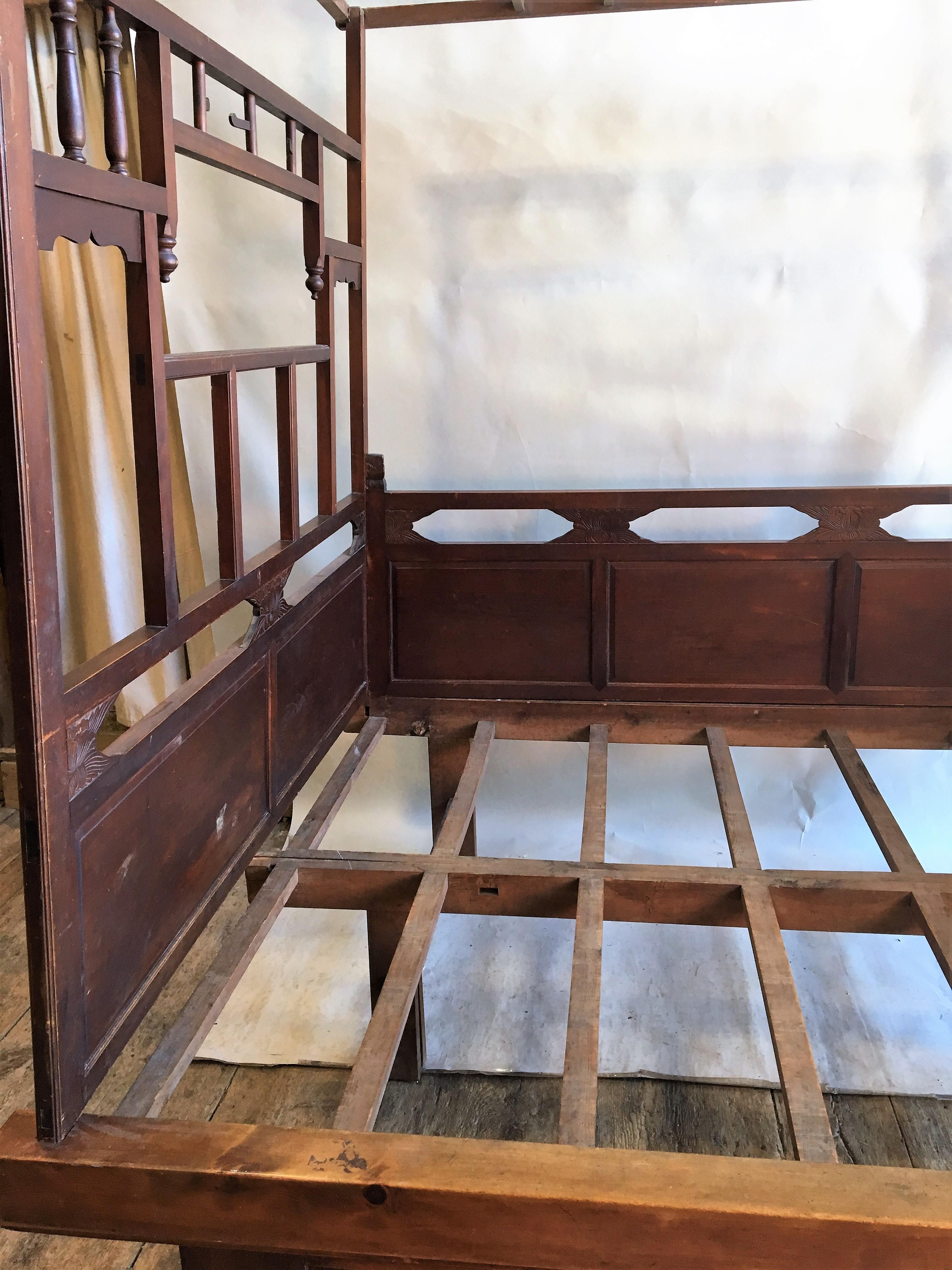 A Chinese wedding bed in carved wood, with lattice canopy supported by side walls with turned wood spindles and carved panels, circa 1890. The bed completely disassembles in minutes and can be easily transported. The base is in 2 halves.