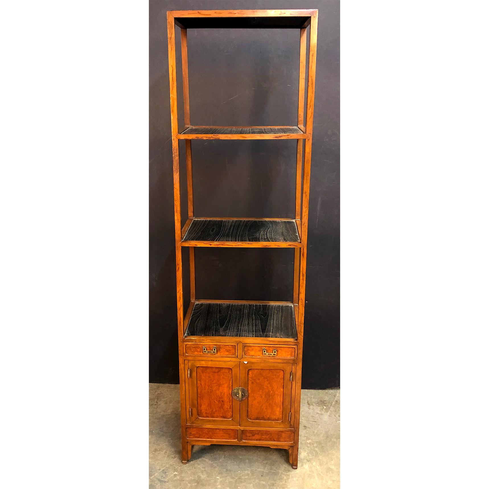 A antique Chinese hardwood and ebonized four-tier tall étagère with lower cabinet section.