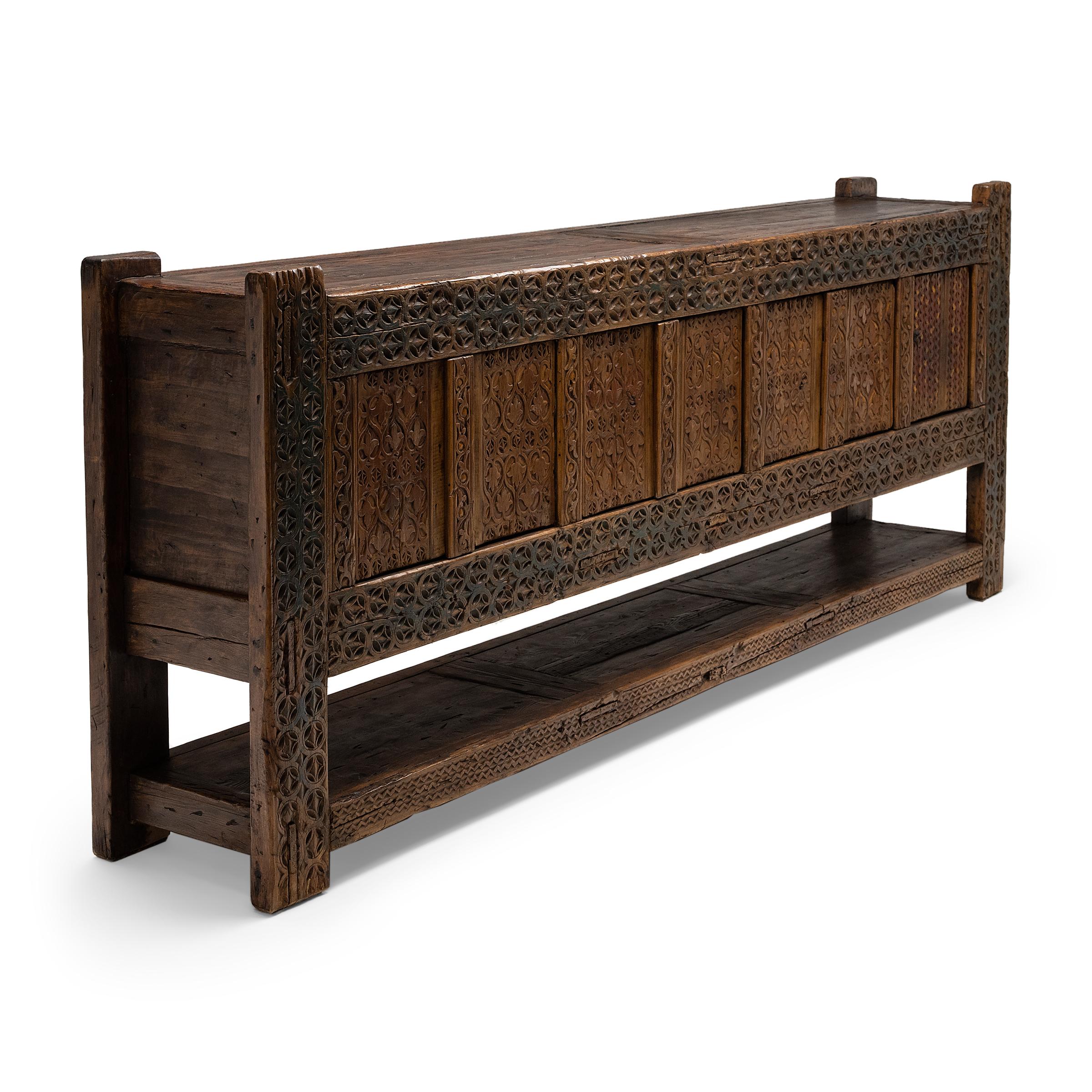 This rustic seven-door coffer from the early 20th century balances modern simplicity with humble, timeworn materials. Attributed to artisans of Xinjiang province in Western China, the sideboard is crafted of pine with mortise-and-tenon joinery and