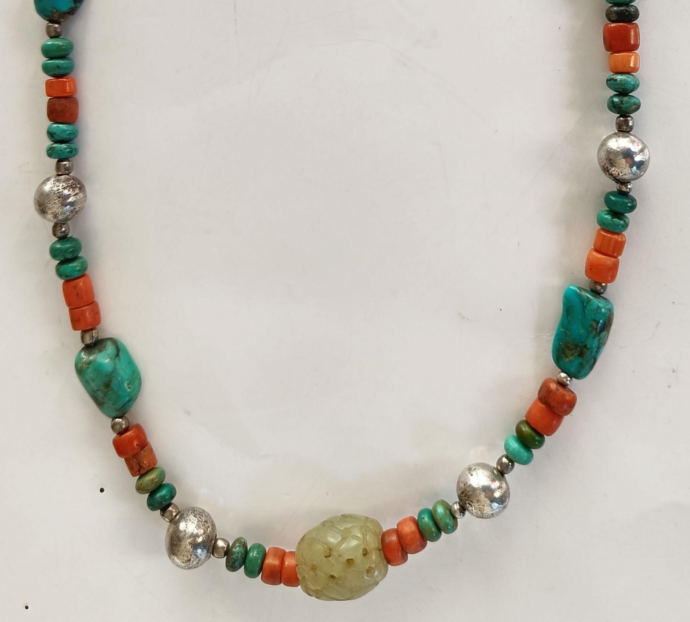 A fine Chinese Ethnic Minority antique turquoise jade coral silver necklace from Bai people Yunnan. 
Coral silver turquoise and malachite with rare central carved lattice work jade bead .
Yunnan ethnic minority China
Period 19th century.
Condition: