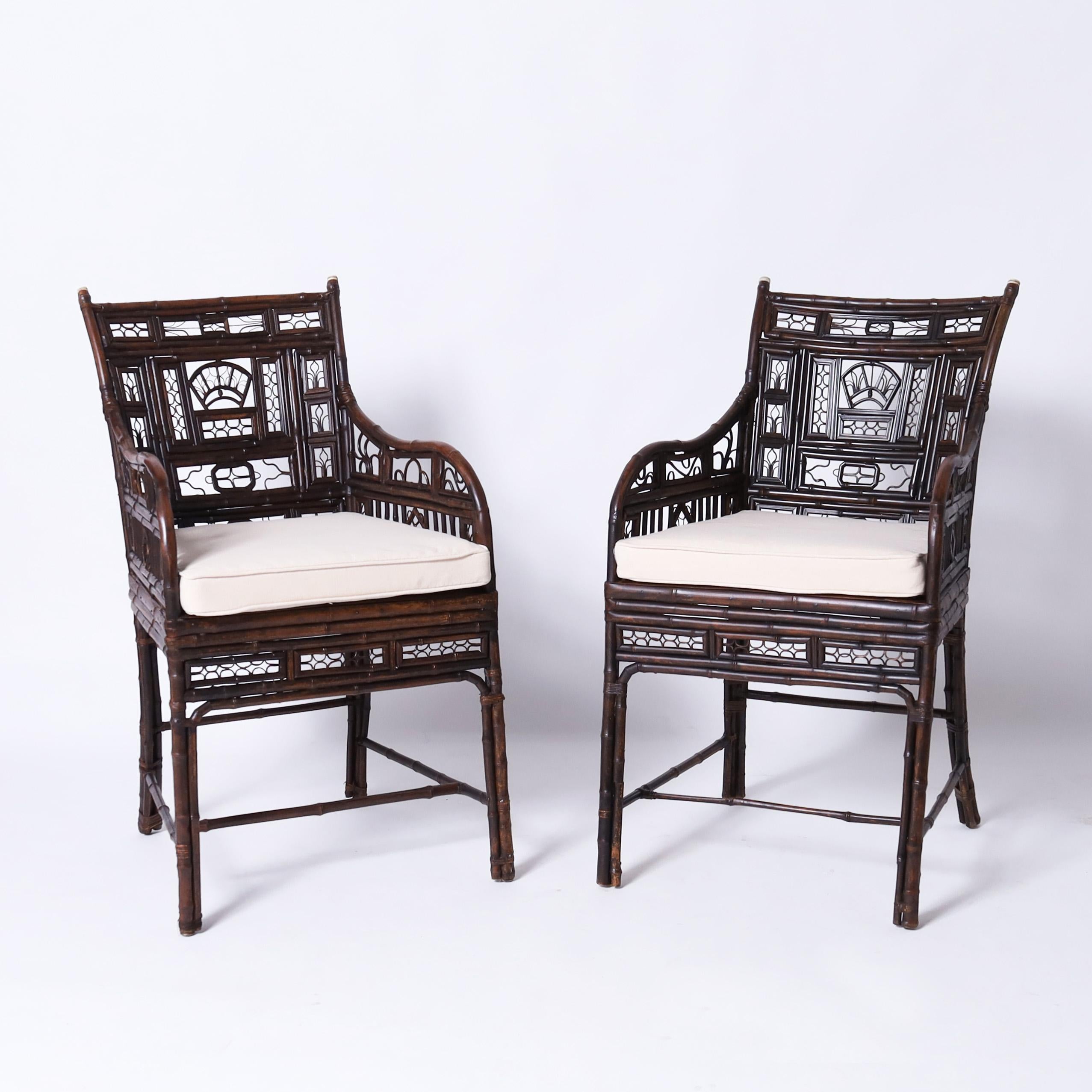 Impressive three piece set of Chinese Export furniture having a pair of armchairs and matching stand handcrafted with bamboo, bent bamboo and rattan, featuring bone finials, pegged construction, and a dark lush finish over classic elegant form.