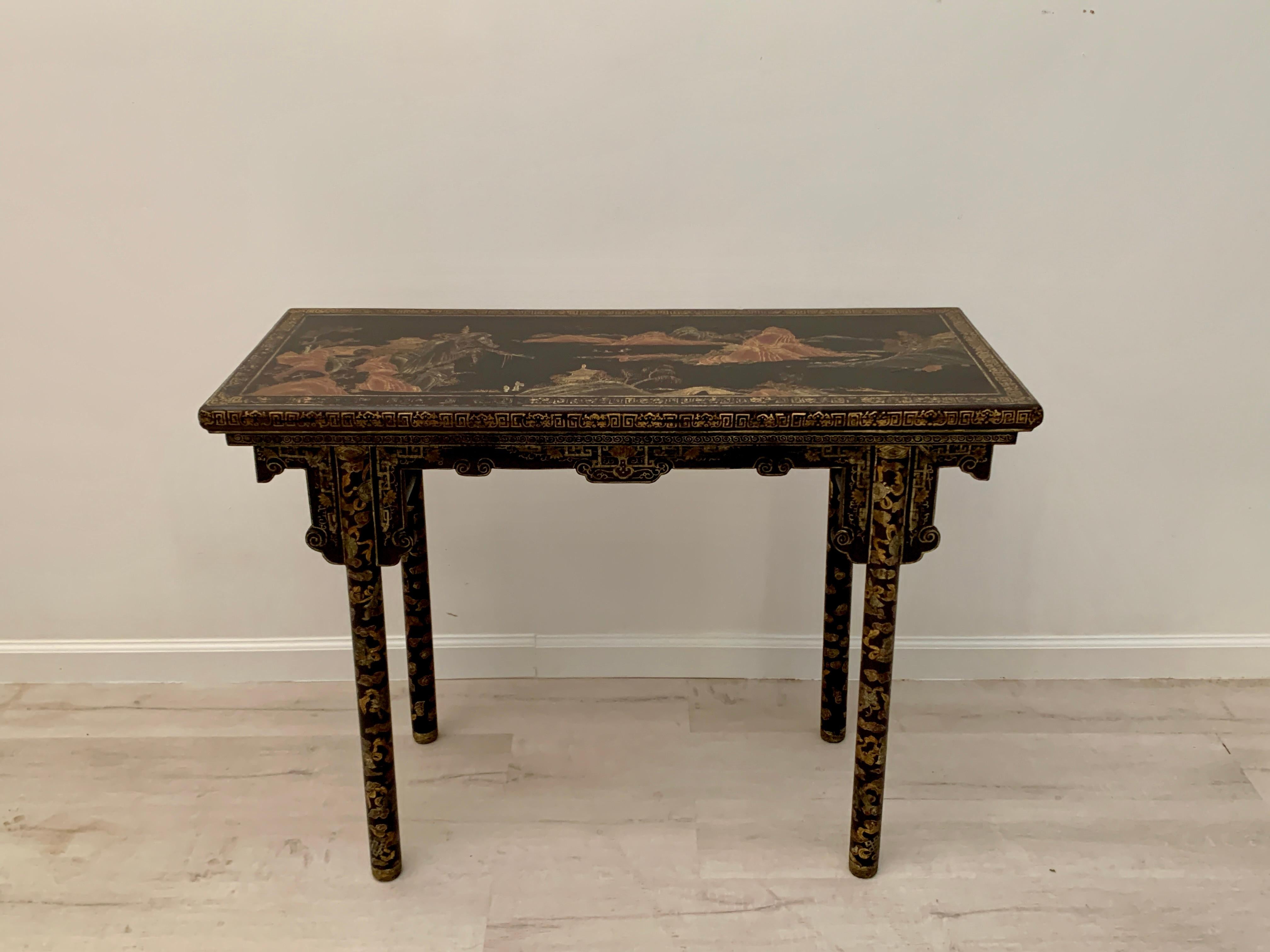 An absolutely lovely small Chinese black lacquer and gilt painted altar console, made for the export market, late Qing Dynasty or early Republic Period, early 20th century, China.

The small and narrow Chinese export console table, sometimes