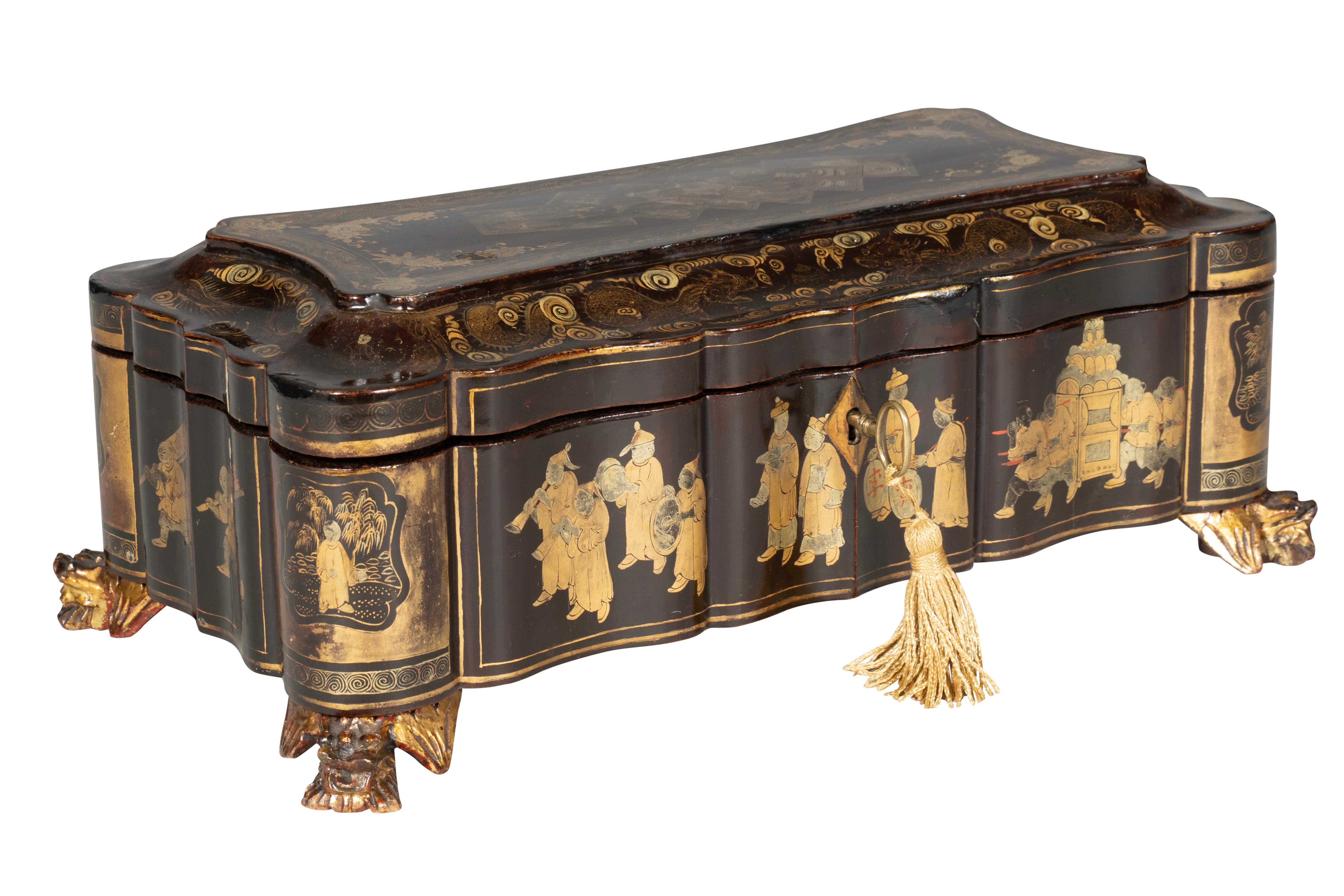 Rectangular hinged shaped top enclosing small trays. Conforming case with gilded feet.