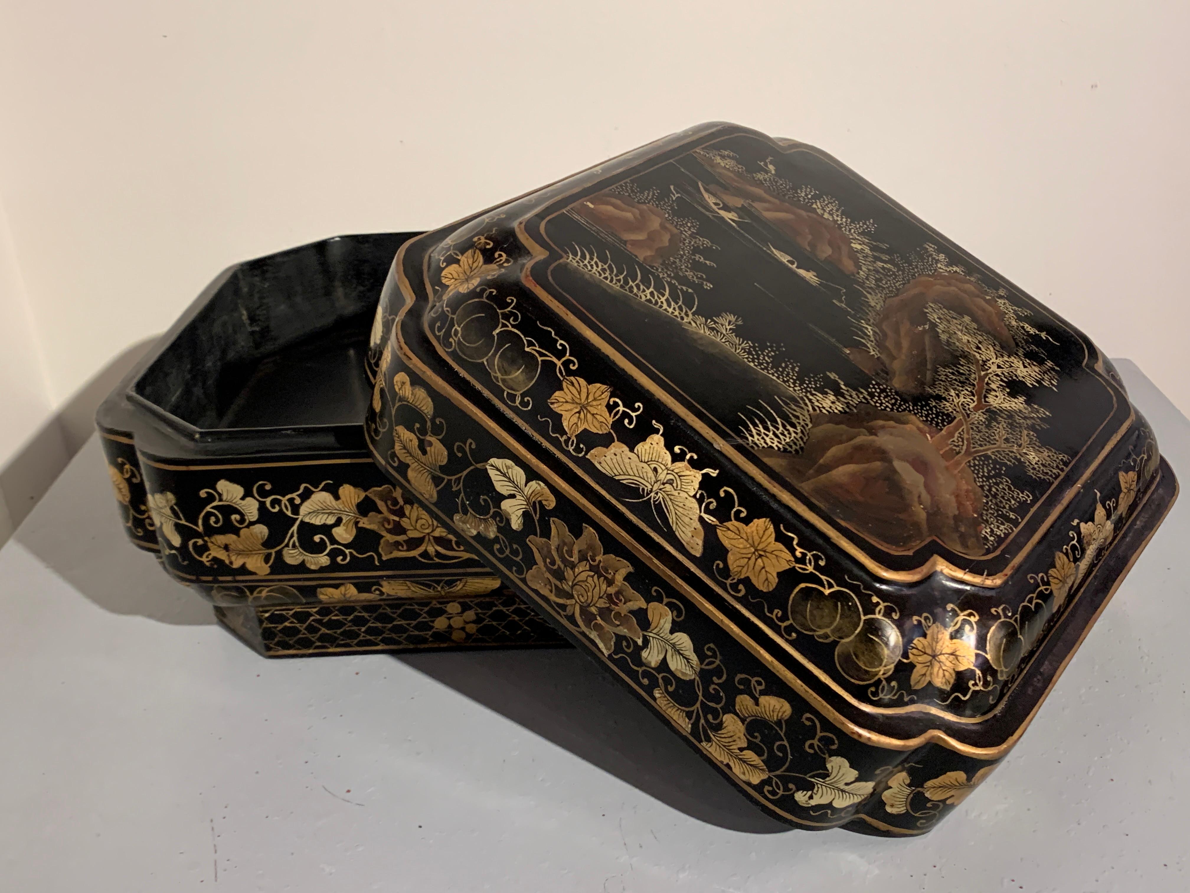 A large and highly decorative Chinese black lacquered wooden box with gilt painted decoration, mid 20th century, China. 

The large box of square quatrefoil form, may originally have been used as a gift box, and filled with food, silks, or other