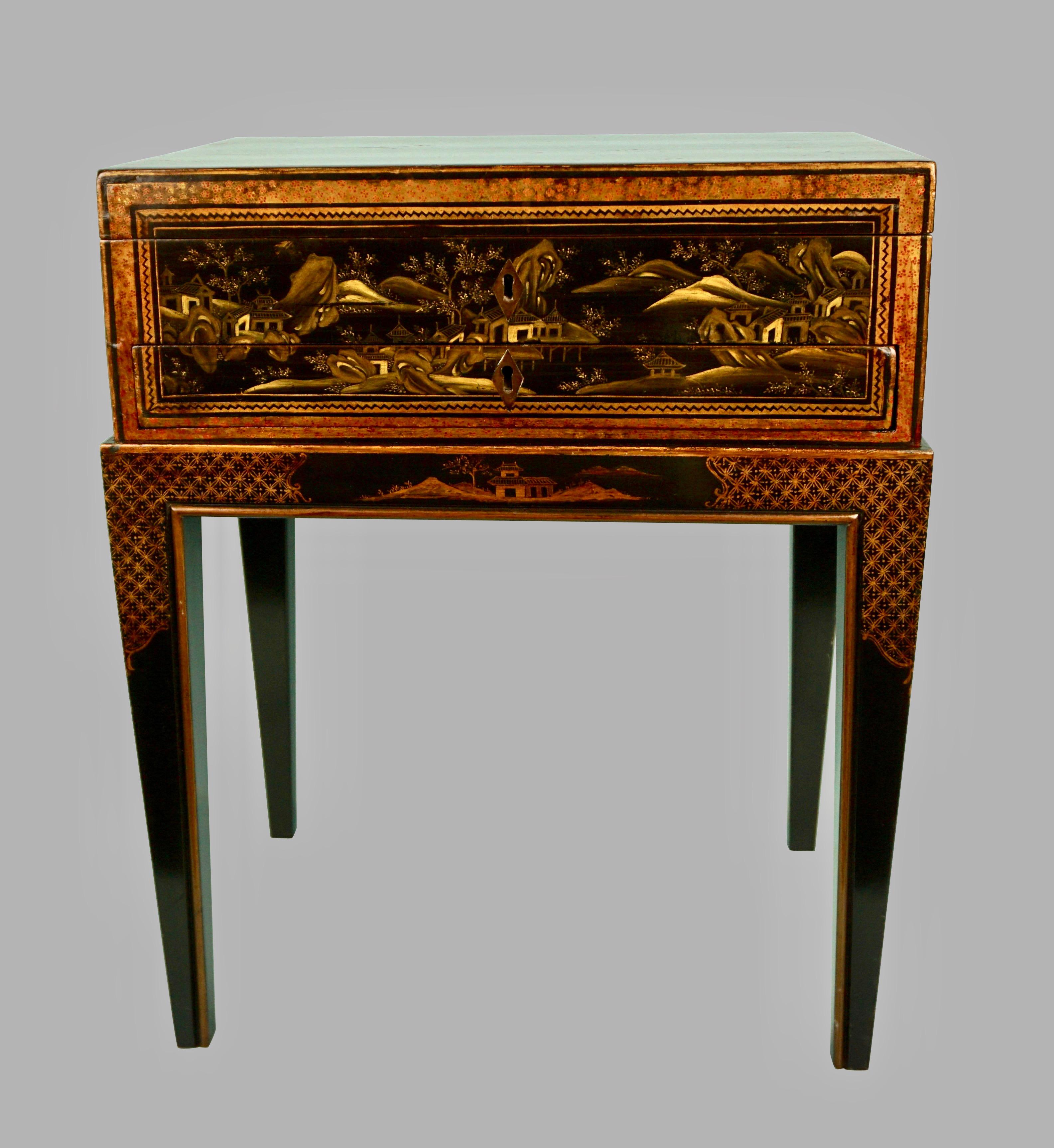A pretty Chinese export black lacquer work box with a central drawer and side handles, the fitted interior with a retractable slide and pen tray, now mounted on a later custom made Chinoiserie stand. Box circa 1870-1890.