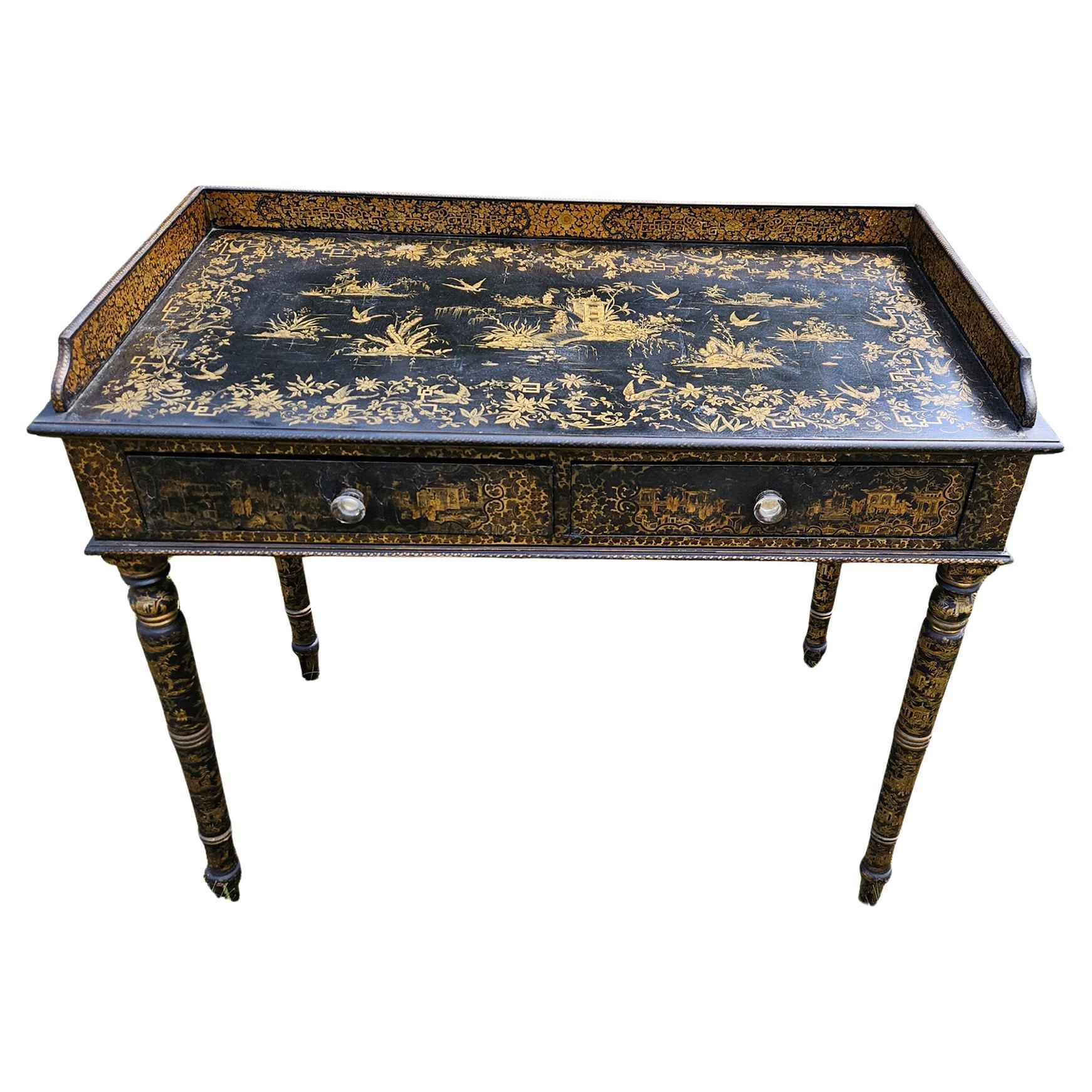 Chinese Export Black Lacquered Writing Desk with Gilt Landscape and Floral Decoration,
Canton,
Early 19th Century

An early 19th century Chinese Export writing desk, produced for the Western market inspired by the Regency, George III style. The