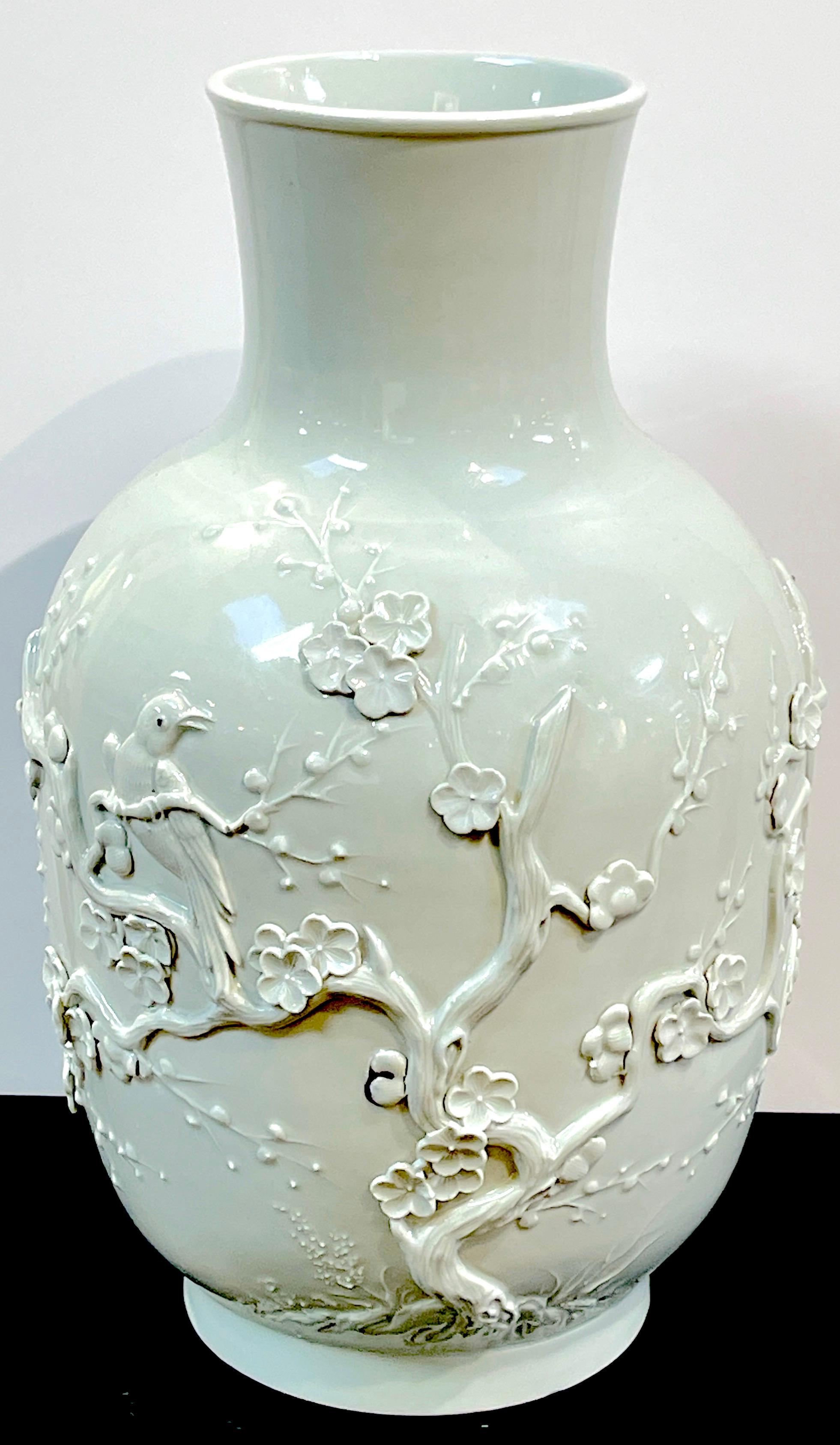 Chinese Export Blanc de Chine Prunus & Bird Motif Relief Vase, Bulbous 
China, 20th Century,  Incised honorific Jiaqing four-character mark 

Enhance your interior with this exquisite Chinese Export Blanc de Chine Prunus & Bird Motif Relief Vase, a