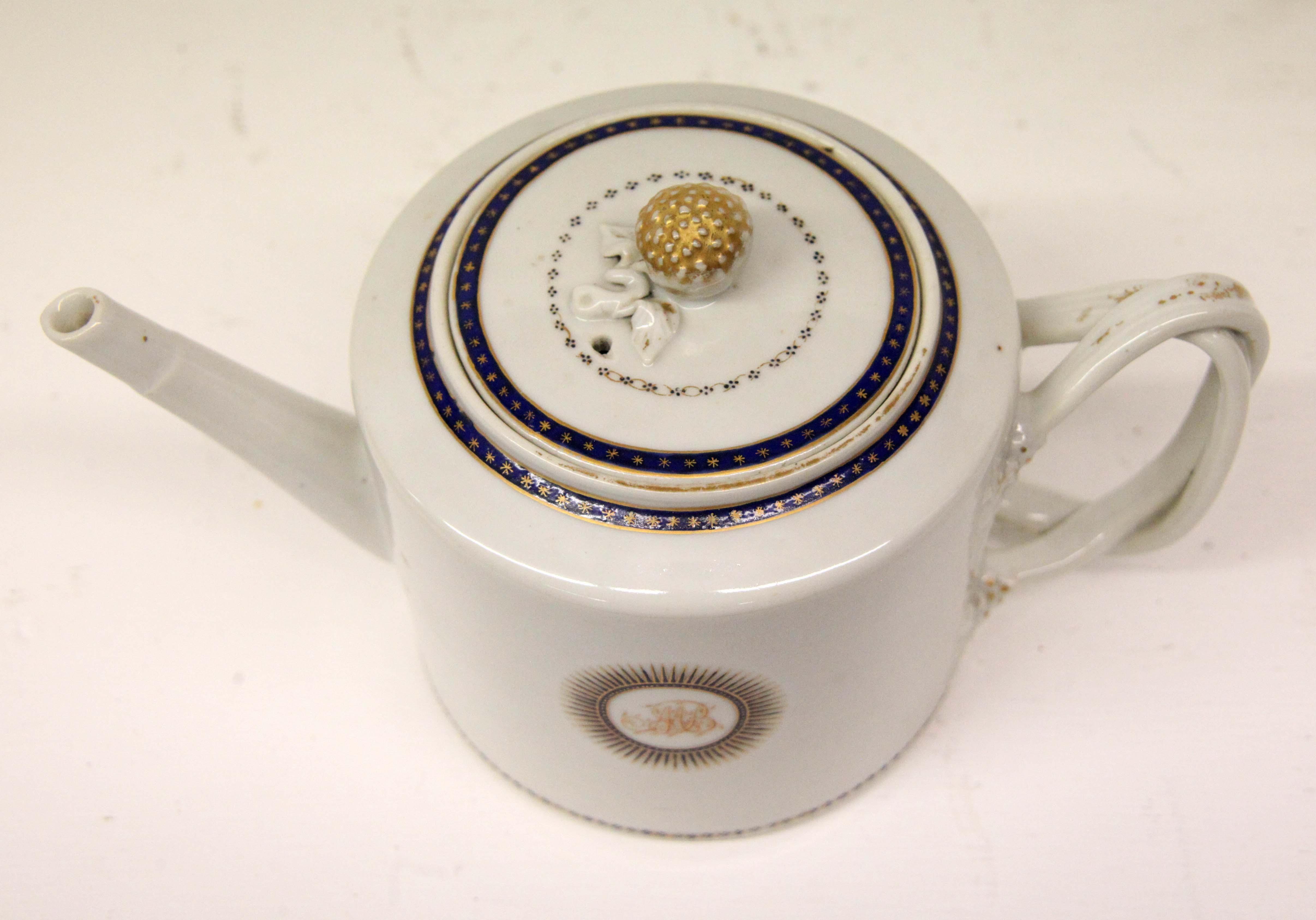 Chinese Export Blanc porcelain teapot, the lid border and teapot rim with cobalt and gilt decoration, acorn finial, teapot body with initialed stylized sunburst, basket weave handle.