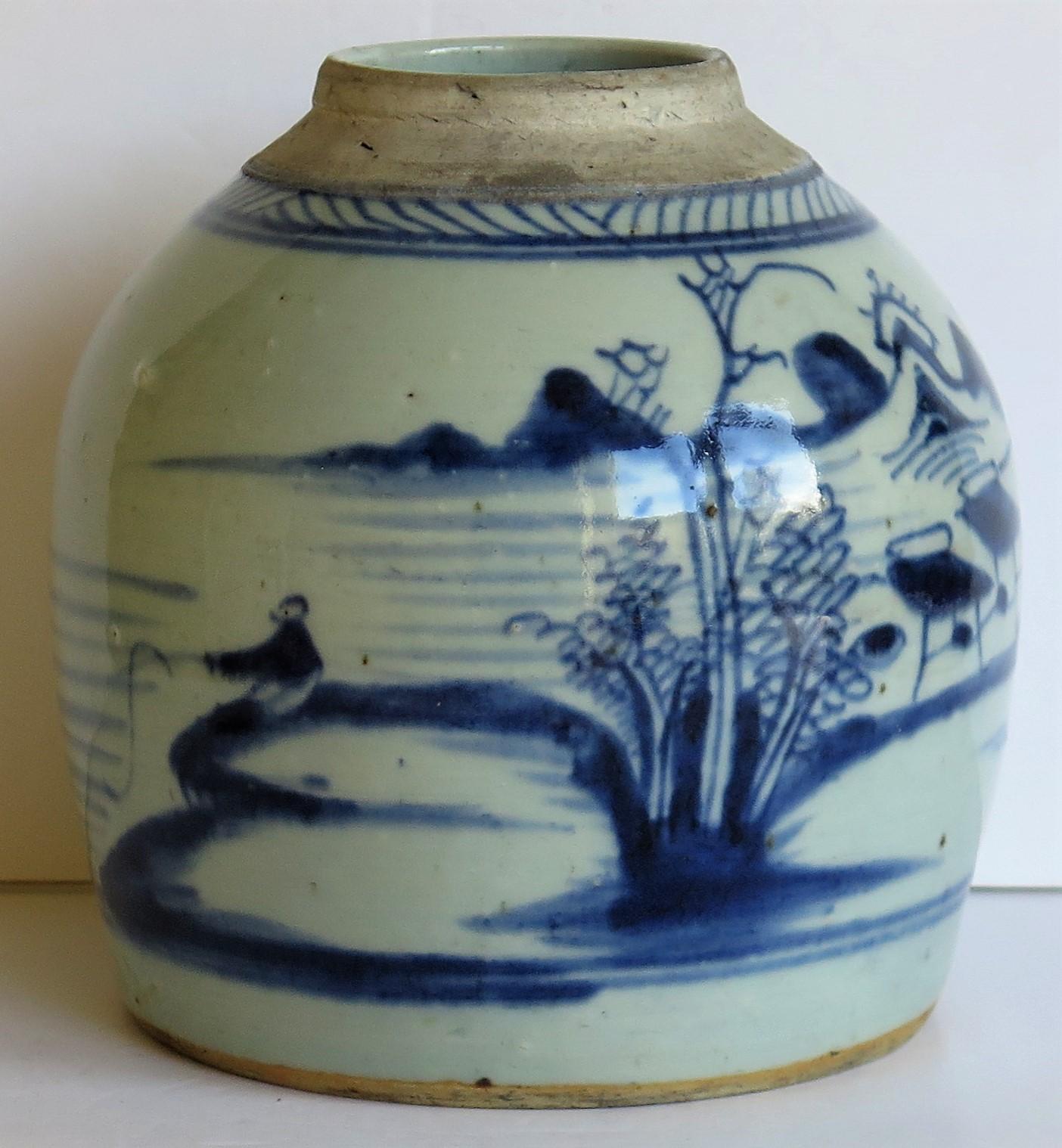This is a heavy Chinese Export porcelain jar hand painted with a blue and white lakeside scene and dating to the late 18th century, Qing dynasty.

This is a well potted piece with a very decorative squat shape and a glassy glaze having a blue