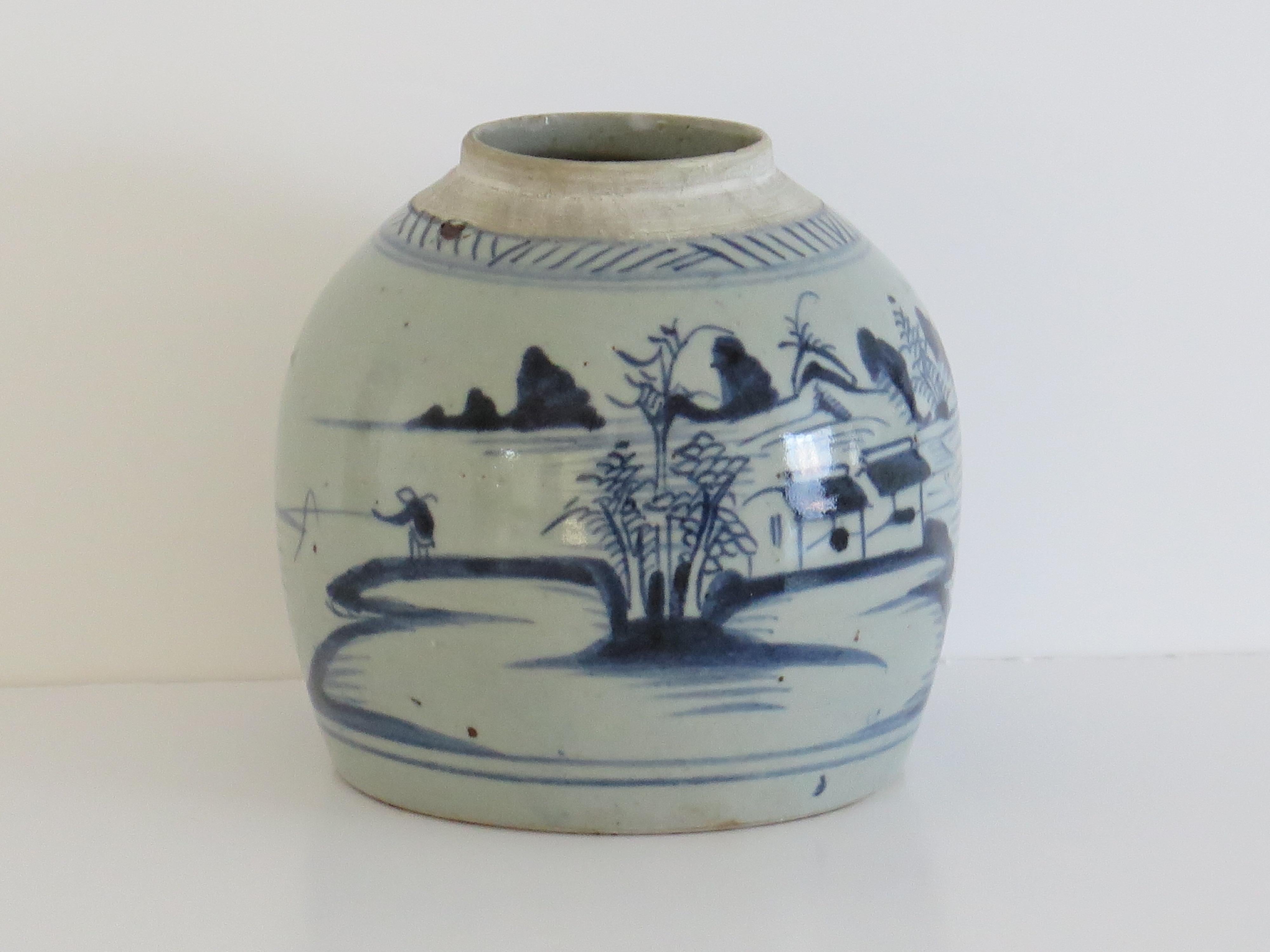 This is a heavy Chinese Export porcelain jar hand painted with a blue and white lakeside scene and dating to the late 18th century, Qing dynasty.

This is a well potted piece with a very decorative squat shape and a glassy glaze having a blue