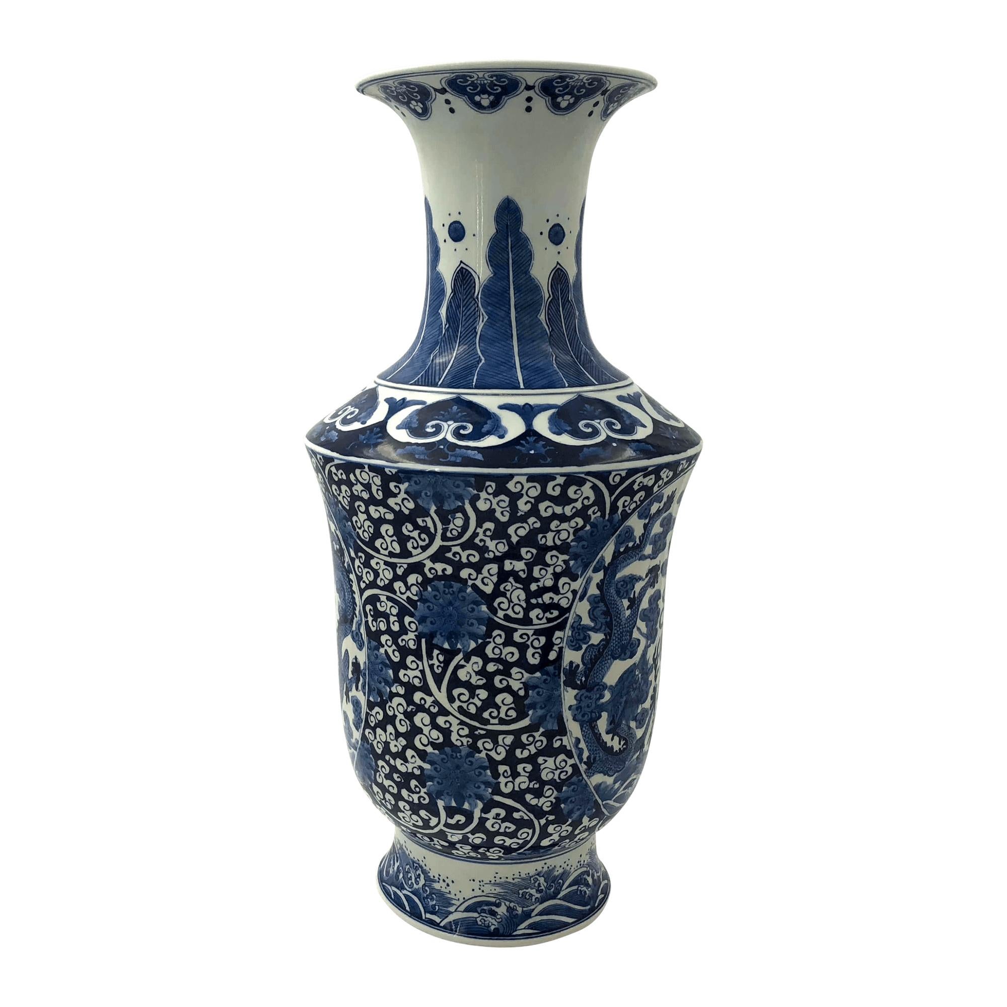 An unusual form Chinese export porcelain blue and white tall vase with flared rim and decorated with flowers.