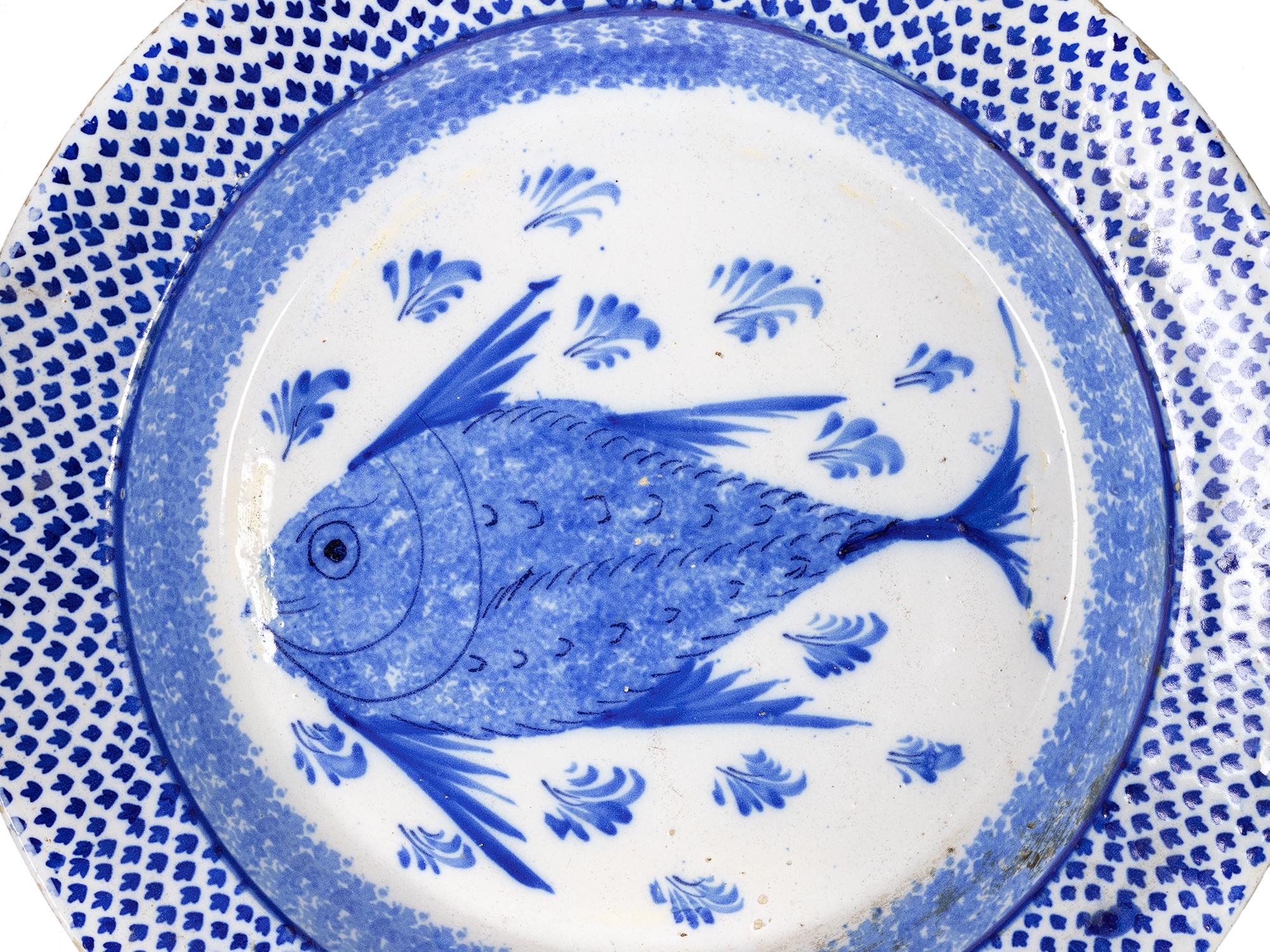 A chinese export large porcelain rounded edges platter with a blue fish in the center.
