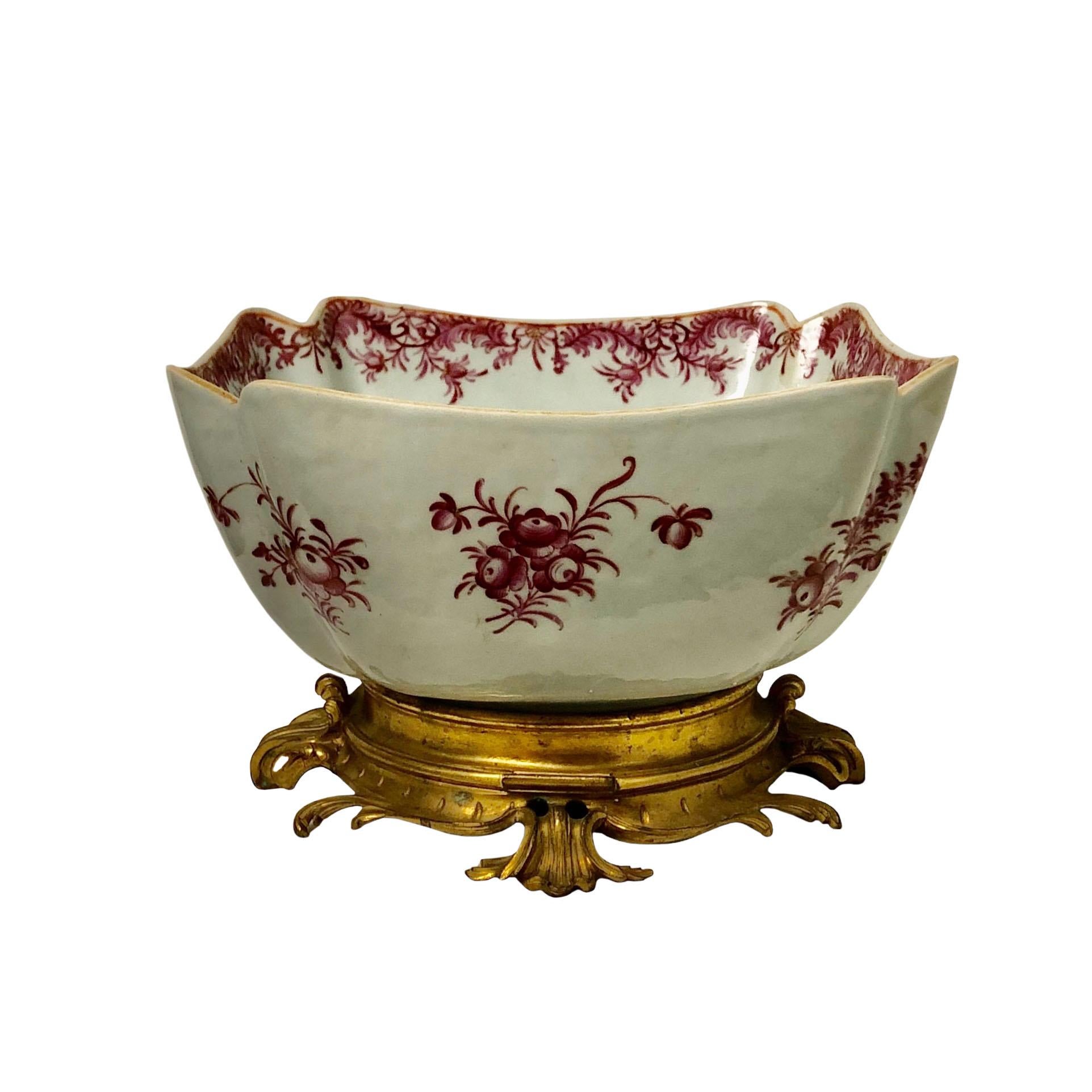 A late 18th century to early 19th century Chinese export bowl with a doré bronze French rococo base mounted onto the bowl. Bowl is decorated with raspberry colored flowers and is in mint condition. The bolt is 10