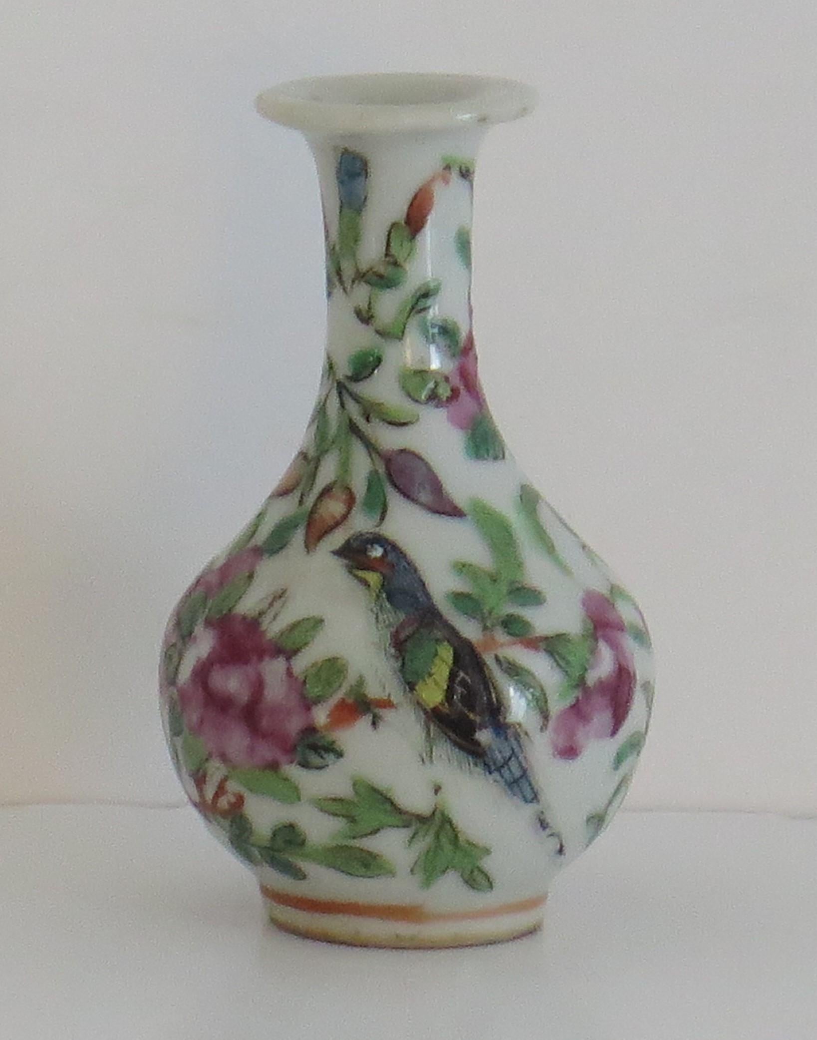 This is a good, decorative Chinese export, Imperial Canton, porcelain, Famille Rose, Small or Bud Vase which we date to the mid-19th century, Qing dynasty, circa 1850.

The vase has a good baluster shape with a tall neck and everted rim, 

It is