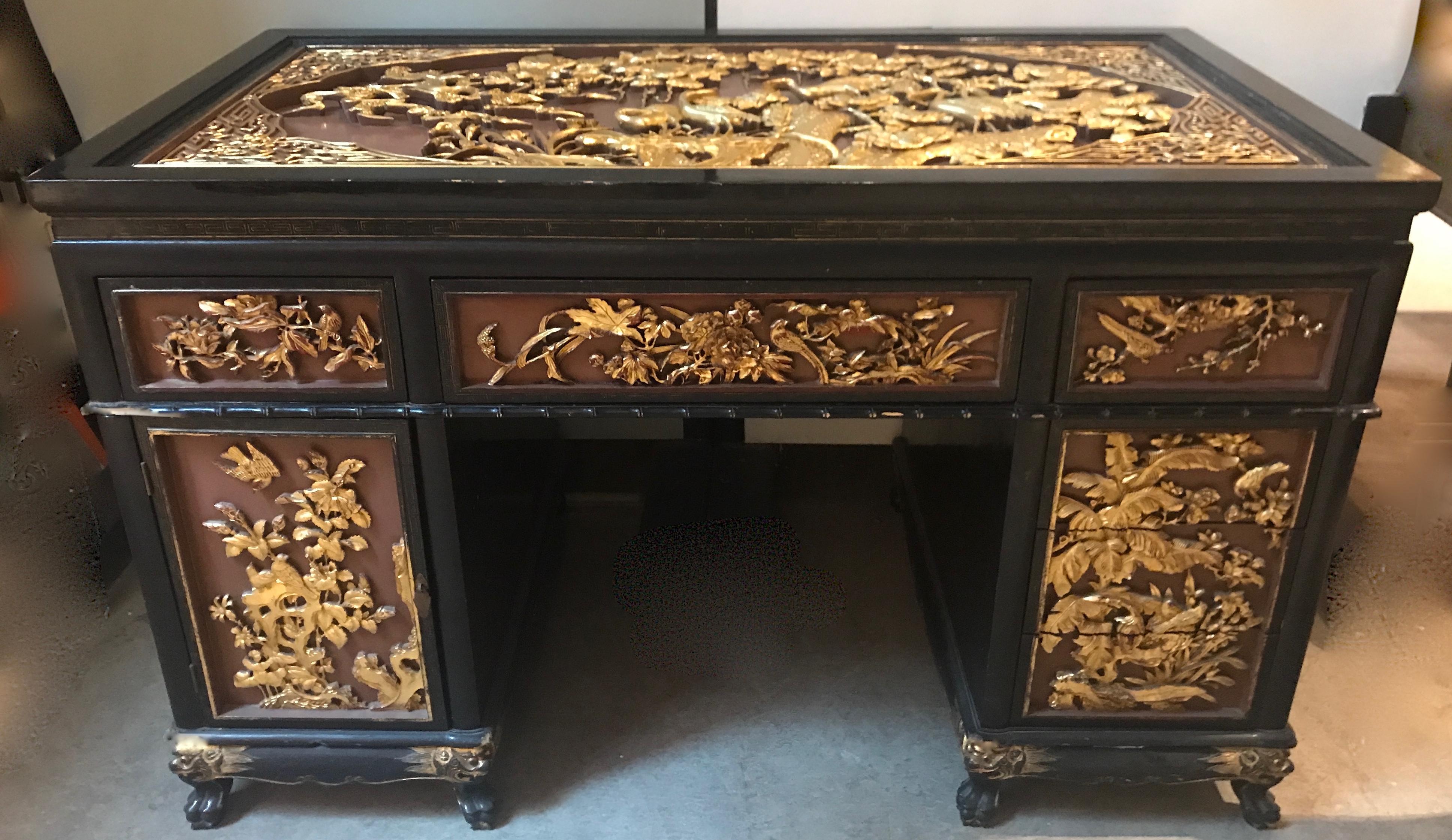 A sensationally chic Chinese export dual pedestal desk with matching chair .The classically British dual pedestal design is embellished with Chinese carvings to perfectly mix the eastern and western taste for the export the European markets.