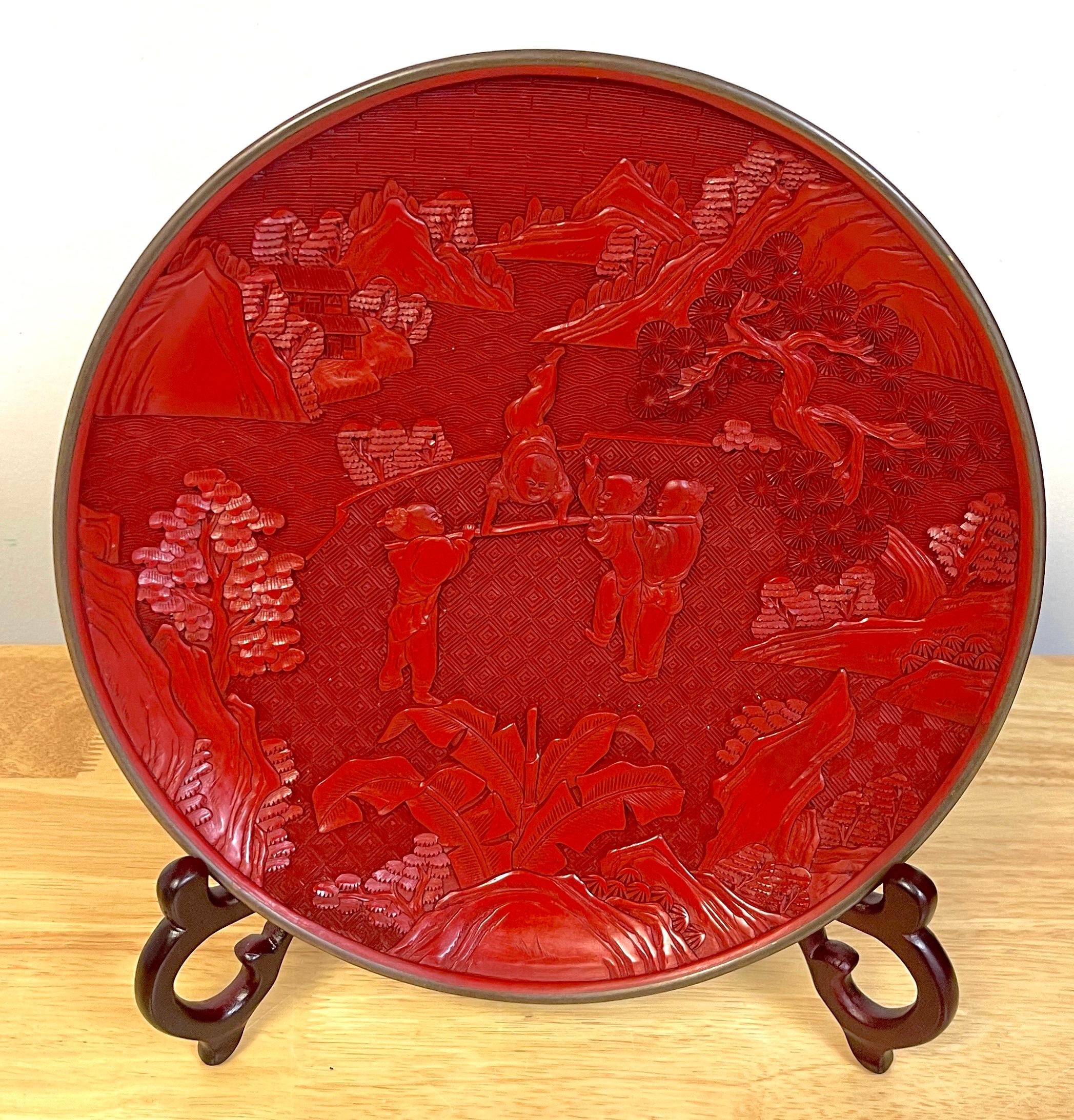 Chinese Export Carved Cinnabar 'Acrobats' Display Plate, & Stand 
China, 20th century 

Depicting four Chinese Acrobats performing in landscape. Unmarked. Includes carved hardwood display stand 


Overall Measurements 
Plate alone 10-Inches