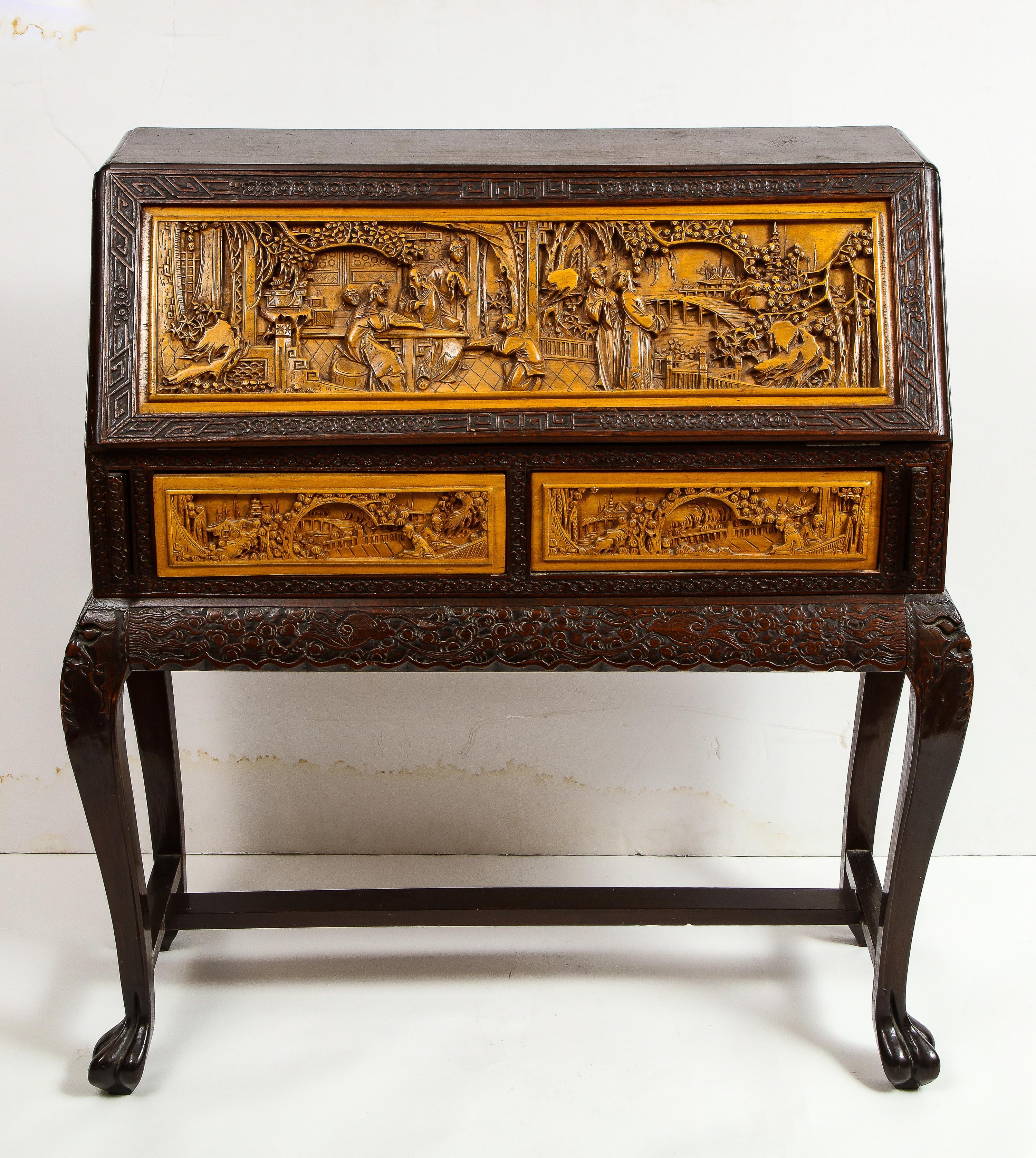 Chinese export carved figural hard wood desk cabinet, circa 1900s.

Depicting scenes of Chinese men and woman throughout. Hand carved. Very nice quality.

2 drawers. Drop down top.

Good condition overall. Slight warp to lid, shrinkage split to