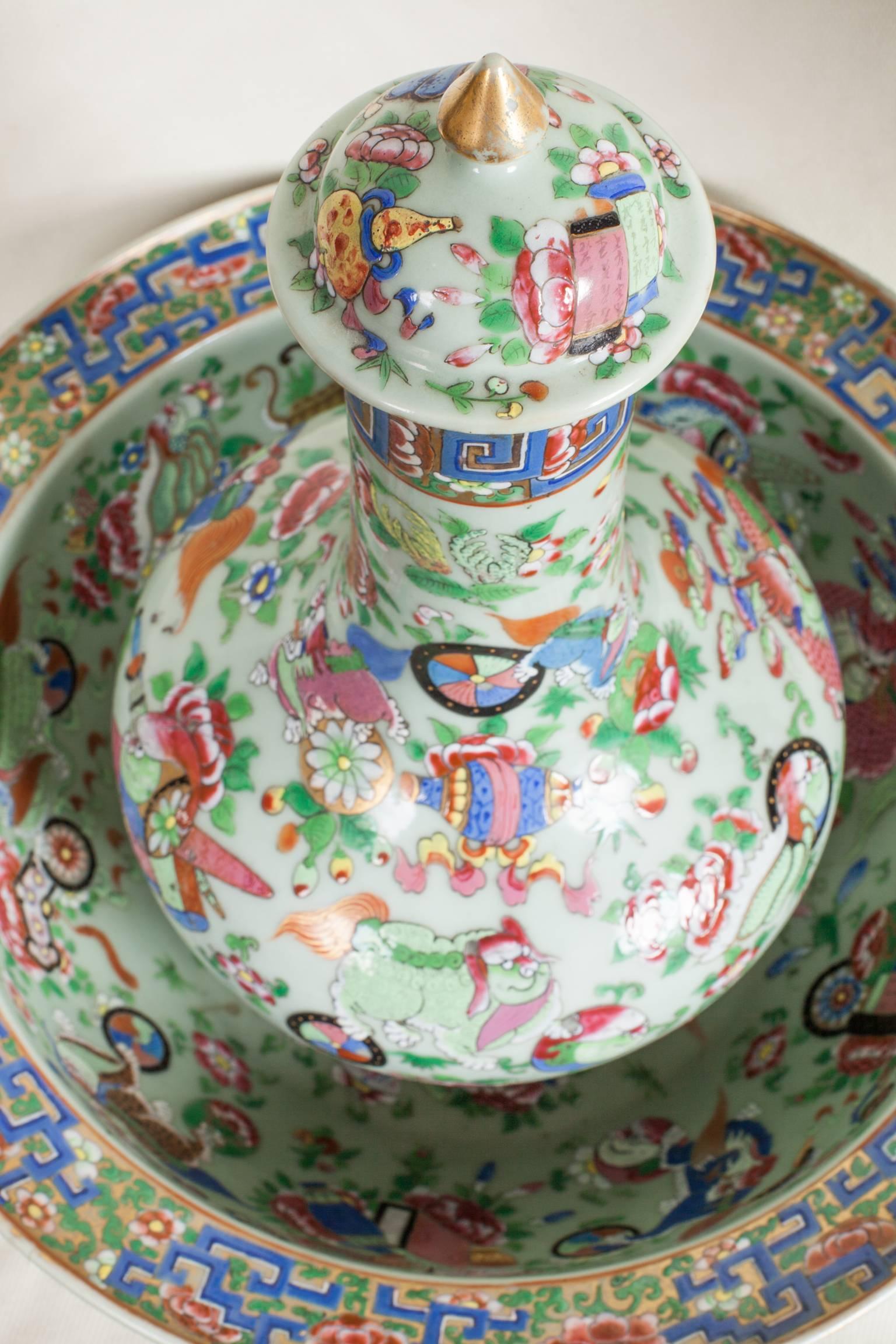 Chinese export celadon porcelain guglet with cover and basin. It is rare to find the guglet with its cover. This set is finely hand decorated with brightly colored enamels representing mythological and imaginary creatures, symbols, scrolls, lotus