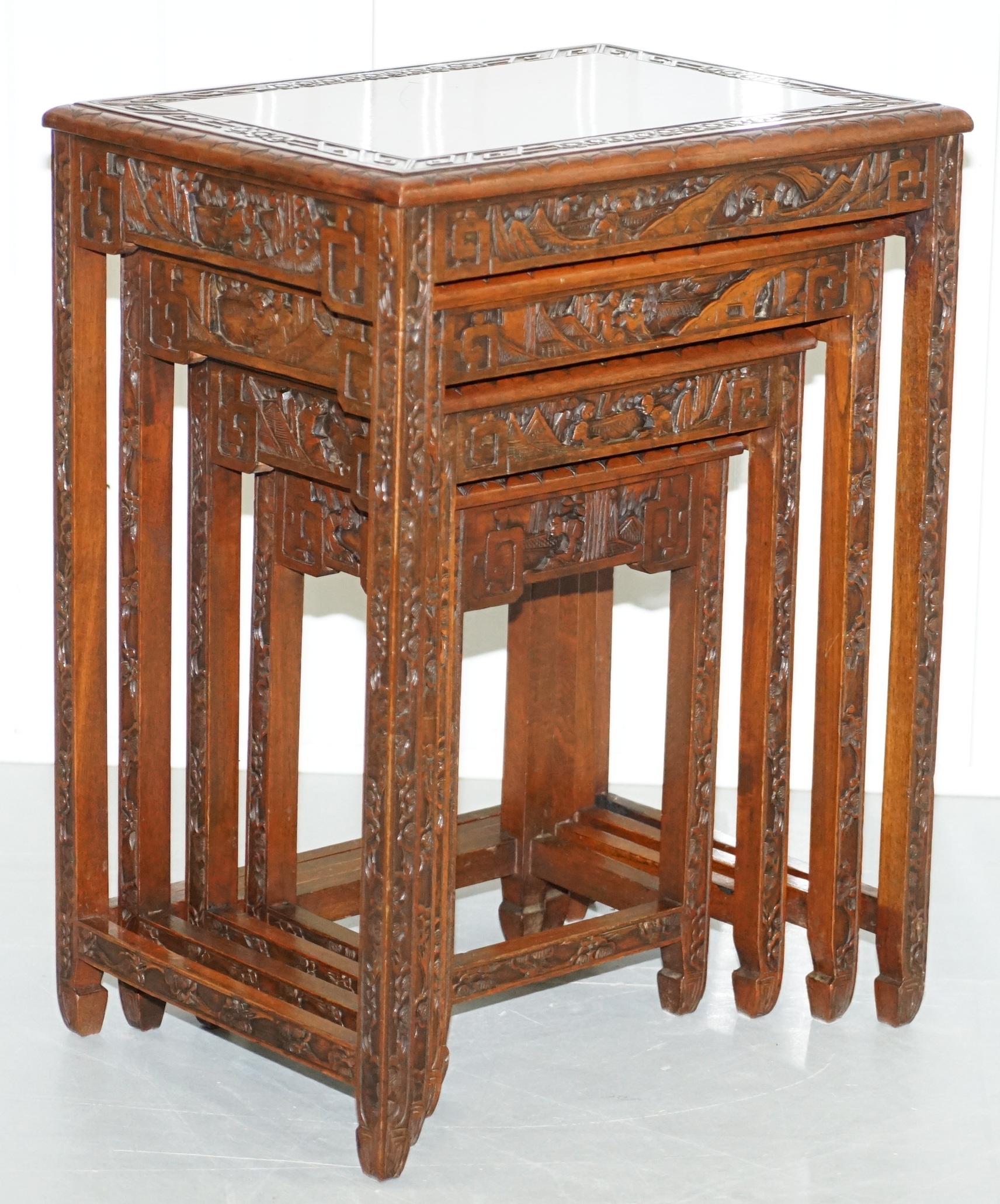 We are delighted to offer for sale this lovely set of circa 1930s solid teak Chinese Export nested tables all heavily carved.

A very good looking suite, its rare to find them with four tables, often its only three. These are heavily carved with