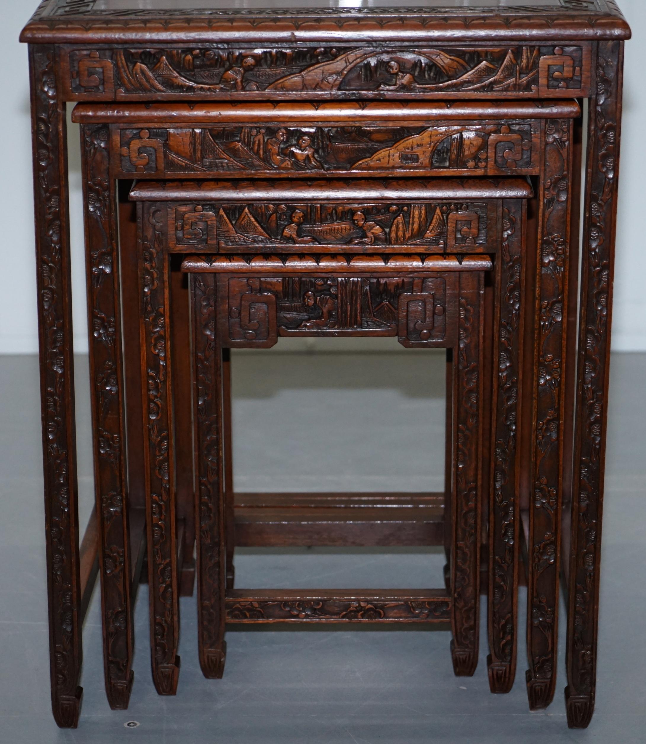 Mid-20th Century Chinese Export circa 1930s Nest of Four Tables Heavily Carved All over in Teak