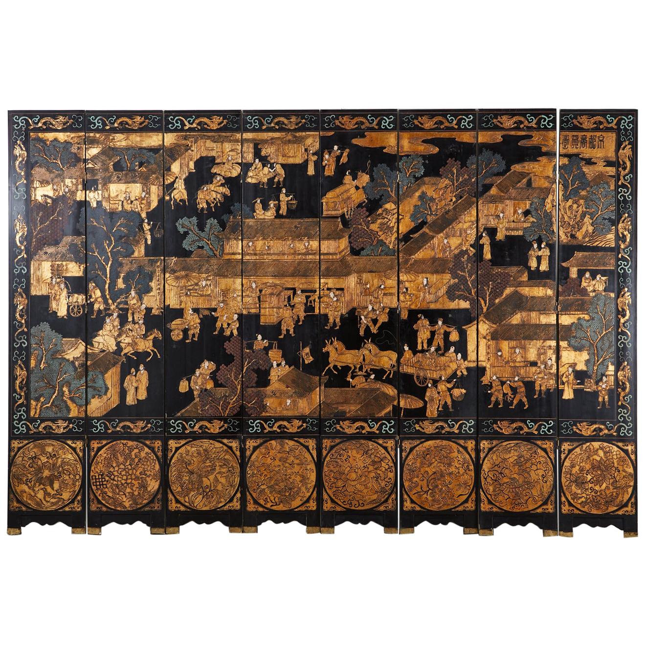 Fantastic Chinese export eight-panel Coromandel screen featuring a busy Chinese village. Black lacquer on wood core panels with Kuancai carved scenes filled with color pigments and gilt. The intricately carved screen depicts figures with animals in