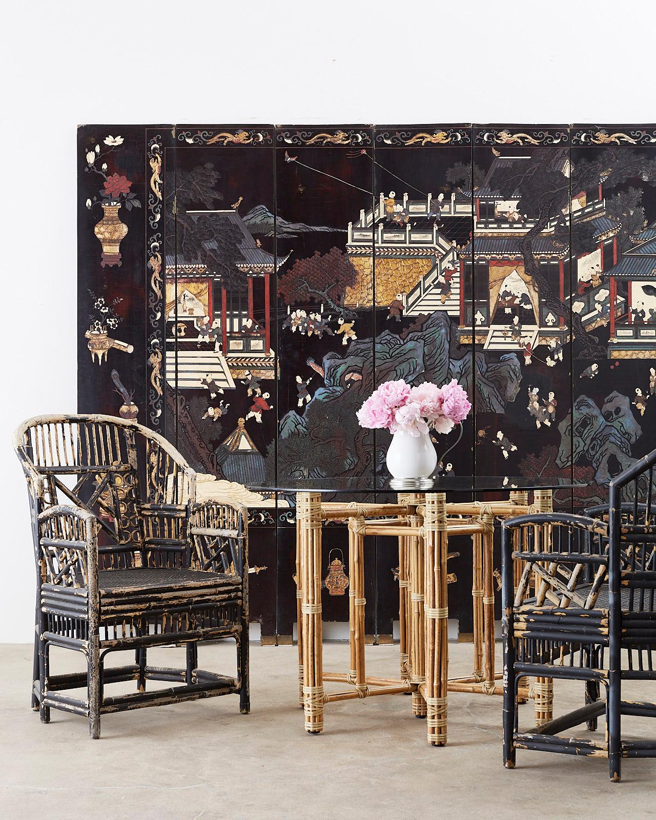 Large Chinese export eight-panel folding coromandel screen depicting young boys playing in a courtyard scene amid pagodas. The reverse side consists of a treed landscape featuring white cranes among flowers and vines. The front is bordered by