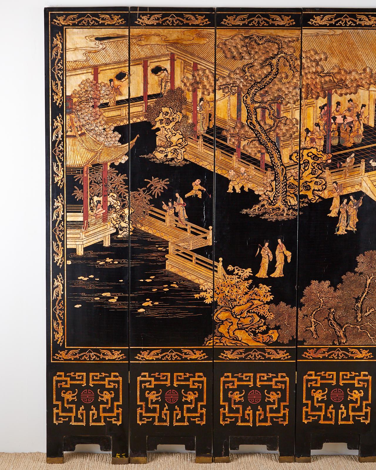 Remarkable Chinese export eight-panel Coromandel screen featuring a golden gilt courtyard palace scene with figures over black lacquer. Beautifully incised thick lacquer with intricate details. Each panel has a red shou symbol on the bottom