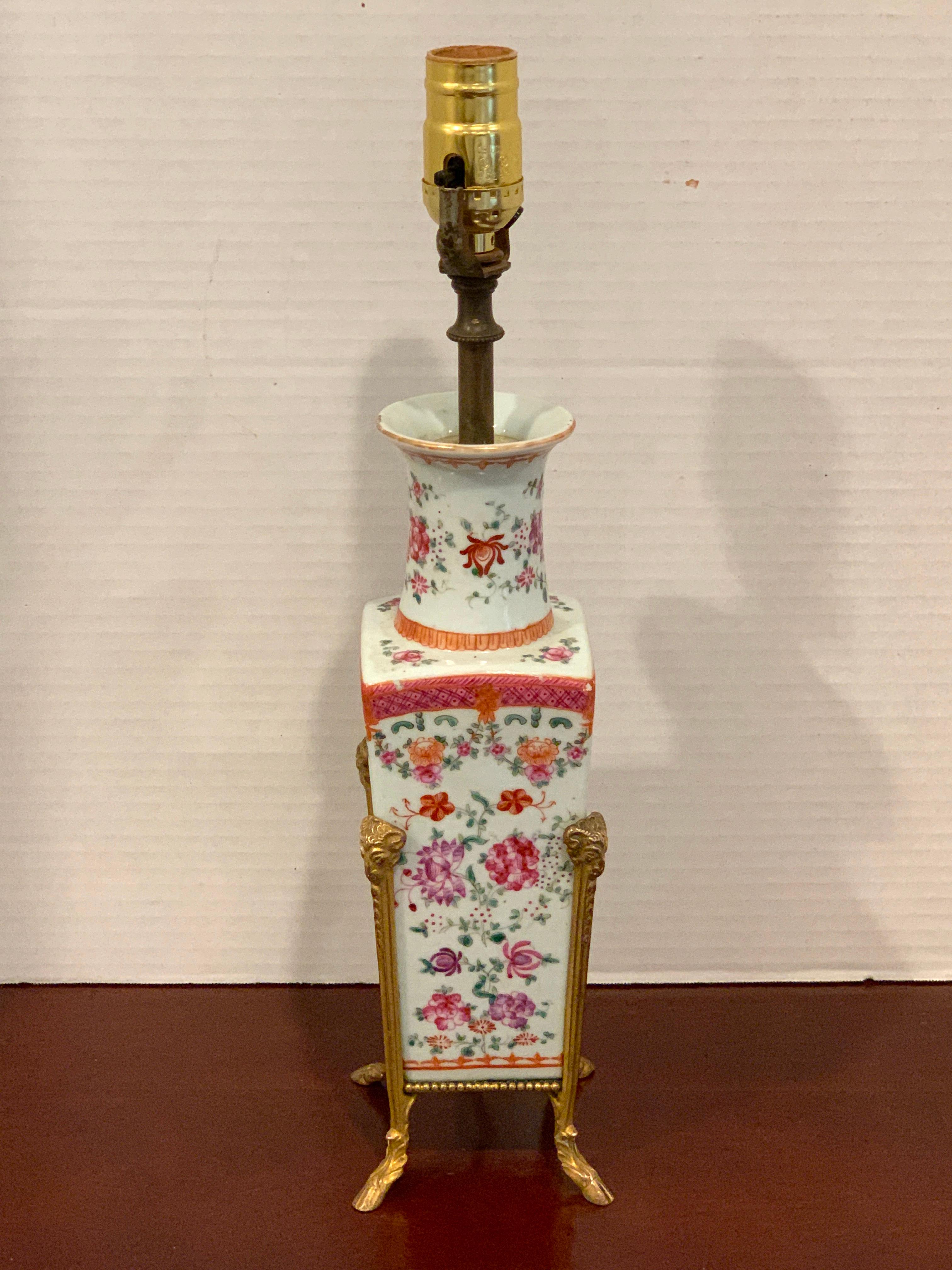 Chinese Export Famille rose ormolu mounted vase, now as a lamp, with typical delicate floral decoration, raised on a ormolu ram and hoof frame. 19th century vase, Lamp Mounts, circa 1925
The height to the top of socket is 16