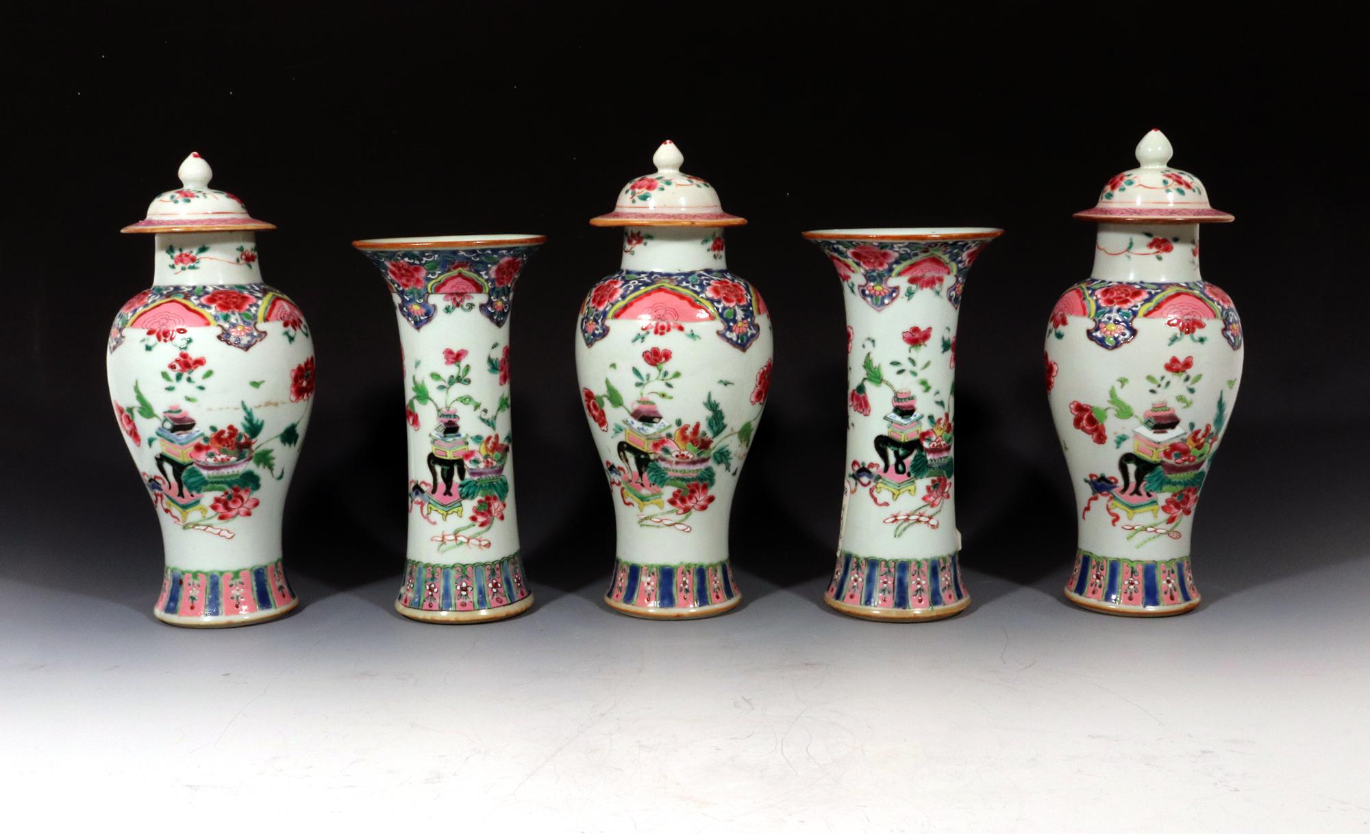Chinese Export Five Piece Famille Rose Porcelain Garniture,
circa 1730-1750

The garniture of five Chinese Export porcelain vases consists of three covered baluster vases and two trumpet-form vases. They are all painted with groupings of precious