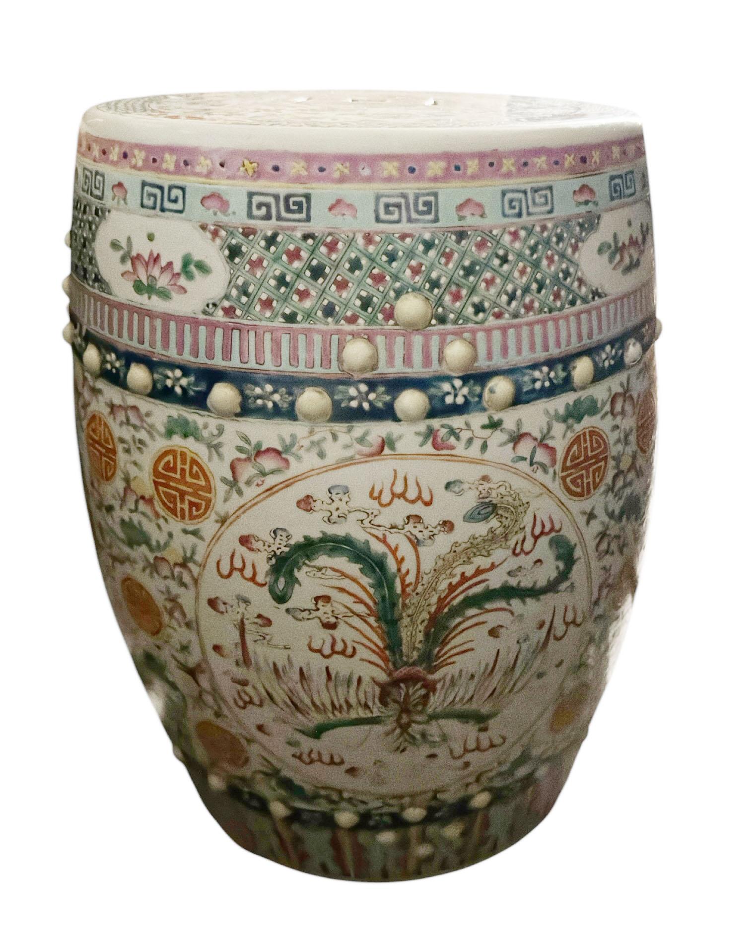 A richly detailed and heavy Chinese terra cotta garden stool, hand painted in the Famille Rose palette and likely dating to the late Qing Dynasty period, circa 1900. 

This sculptural piece features a pierced top, raised gilt enamel accents, and