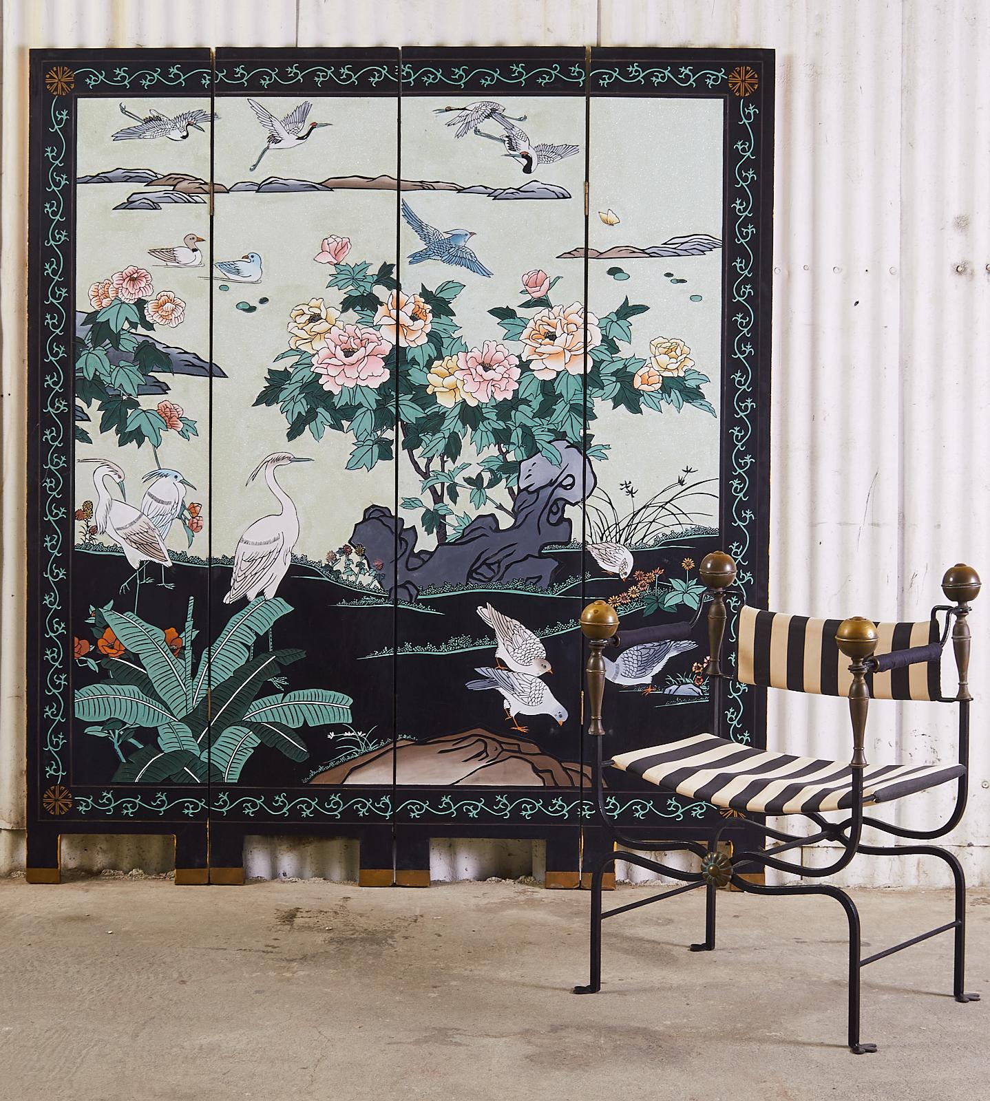 Imposing Chinese export four-panel lacquered coromandel screen depicting a flora and fauna landscape with a dramatic pearlescent white sand background. Rare mint green foliage and white cranes stand out boldly against the black and white ground. The