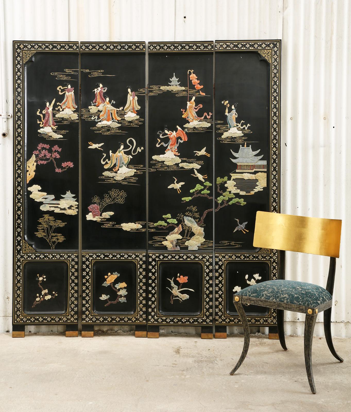 Stunning 20th century Chinese export four-panel lacquered coromandel screen featuring hand-carved soapstone beauties in a floral pagoda landscape with gilt clouds. The highly decorative screen has recessed borders which showcase intricate