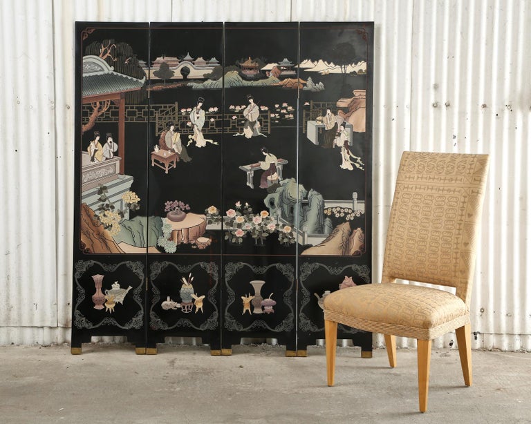 Gorgeous Chinese export four-panel coromandel screen featuring a courtyard scene of beauties engaged in leisurely activities. The lacquered panels are incised and painted in soft pastel color pigments that stand out boldly against the black lacquer.