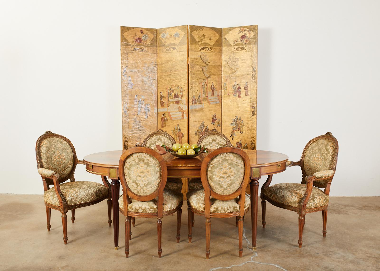 Qing style Chinese export four panel lacquered folding coromandel screen featuring a dramatic gilt background. The front of the screen is decorated with a pagoda court scene with figures engaged in leisurely activities. The scene is bordered with a