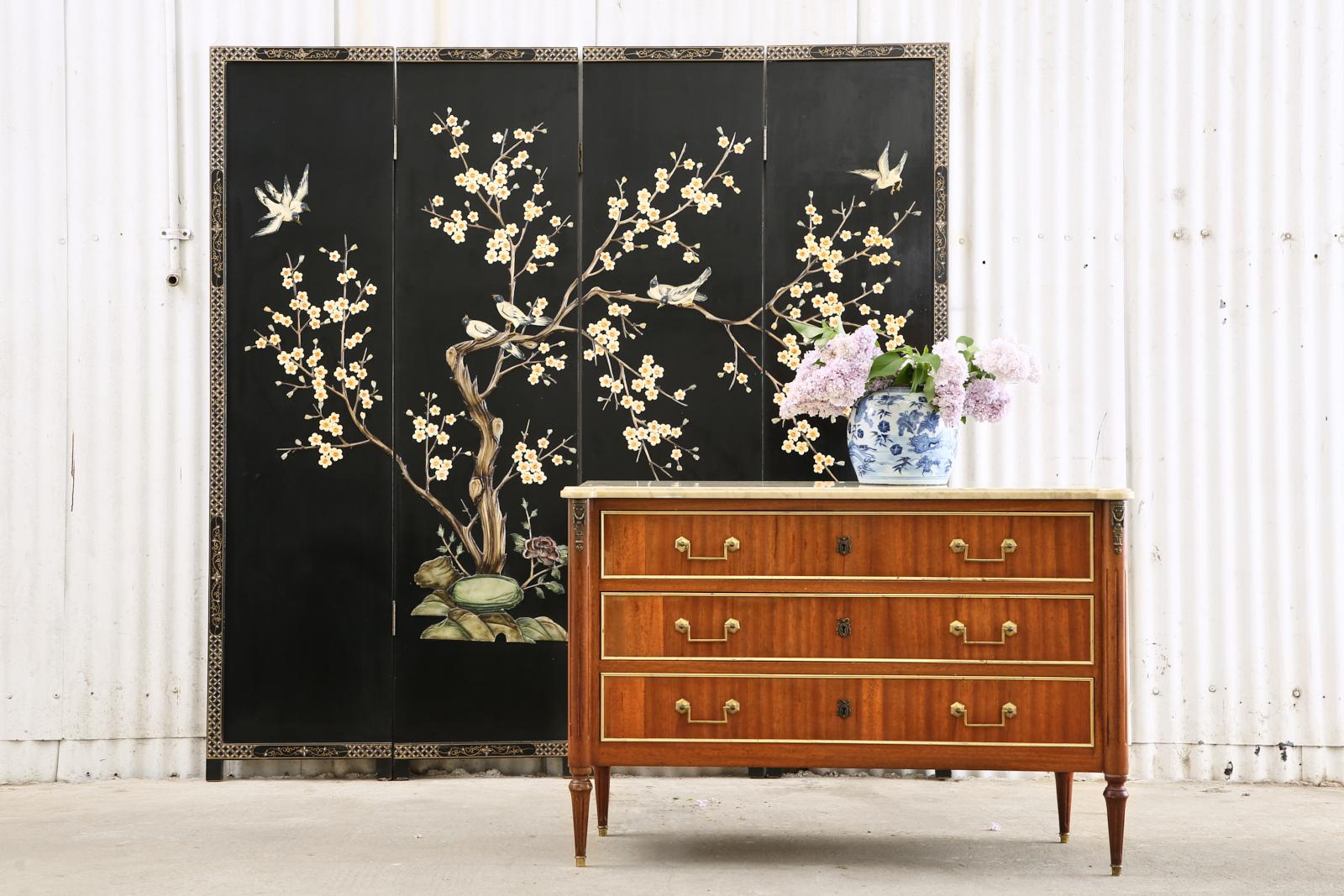 Cheerful Chinese export four-panel coromandel screen featuring carved soapstone. The lacquered panels depict a large blossoming spring tree with songbirds. The scene is bordered by a geometric parcel-gilt frame on the edge of each panel. The lacquer