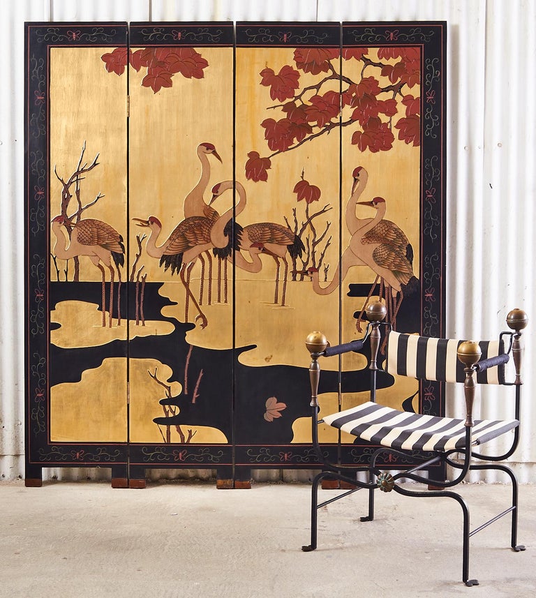 Fantastic Chinese export four-panel lacquered coromandel screen featuring an idyllic pond landscape with eight red crowned cranes or Manchurian cranes. In Taoism the Manchurian crane is the symbol of longevity and immortality. The cranes are