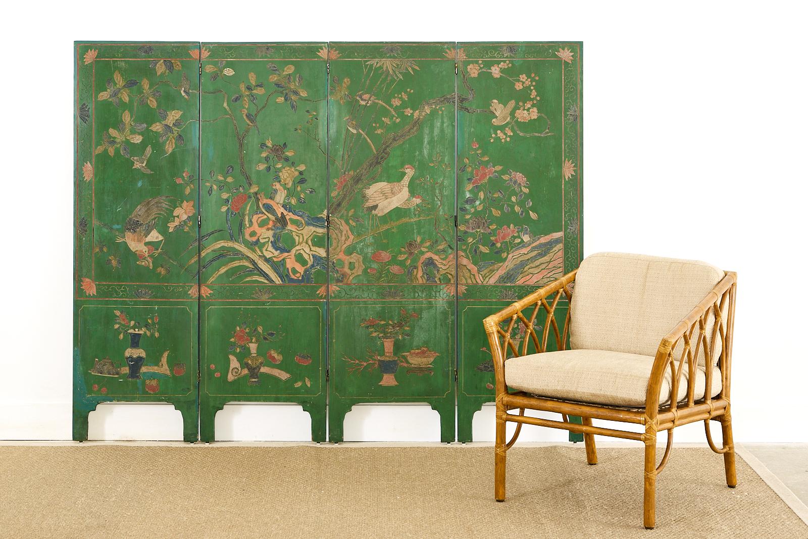 Fascinating early 20th century Chinese export four-panel lacquered coromandel screen. The double sided screen features an emerald green ground with flora and fauna landscape on one side and a traditional pagoda pavilion with figures on the other