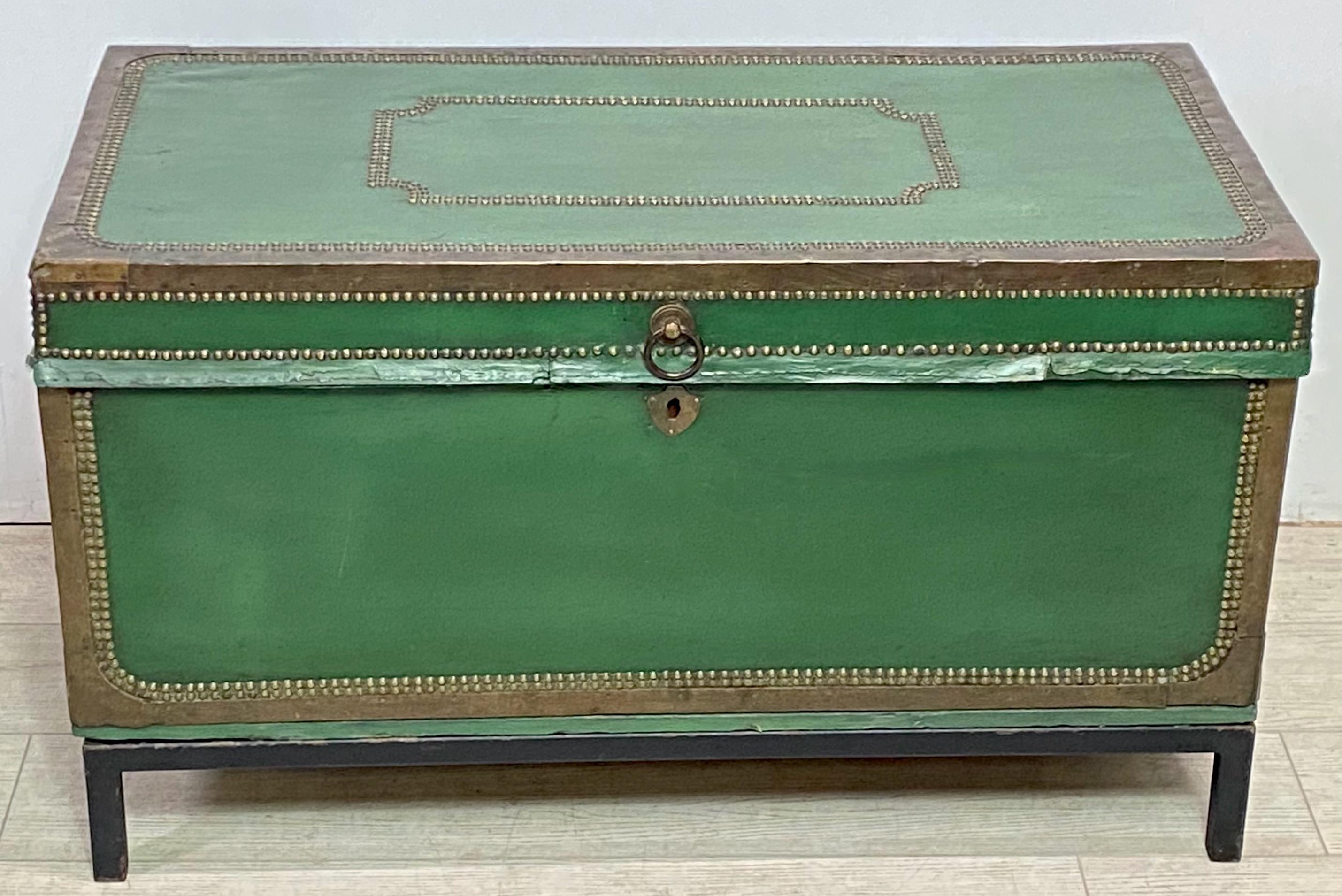 Chinese Export leather covered camphor wood trunk on custom made iron base.
Green leather with brass and nailhead detail.
Late 18th century / Early 19th century.
The stand measures 5 inches high.