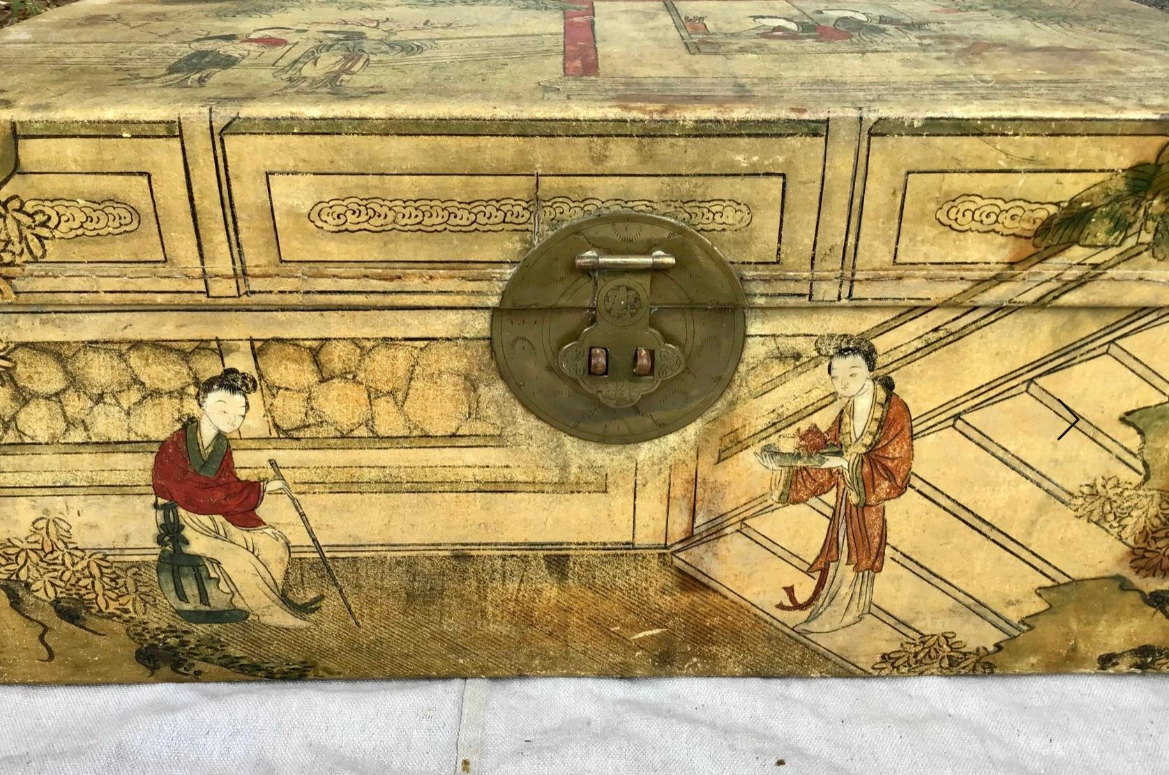 This Chinese export trunk is painted with a colorful scene with pavilions and beautiful women in a garden setting, mounted with brass backplate and hasp with carrying handles to the sides; lined with silk. Painted on vellum with court ladies in