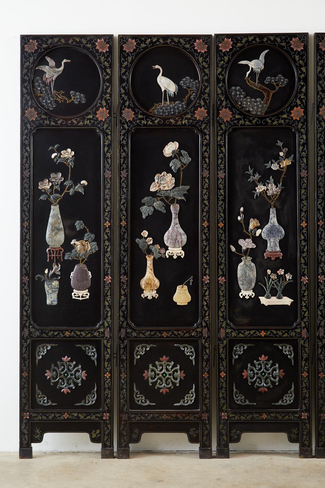 Exceptional Chinese export six-panel lacquered coromandel screen featuring intricately carved hardstone, soapstone, jade, and Shoushan stone from Northern Fujian. The folding panels are lacquered and have three inset windows depicting white